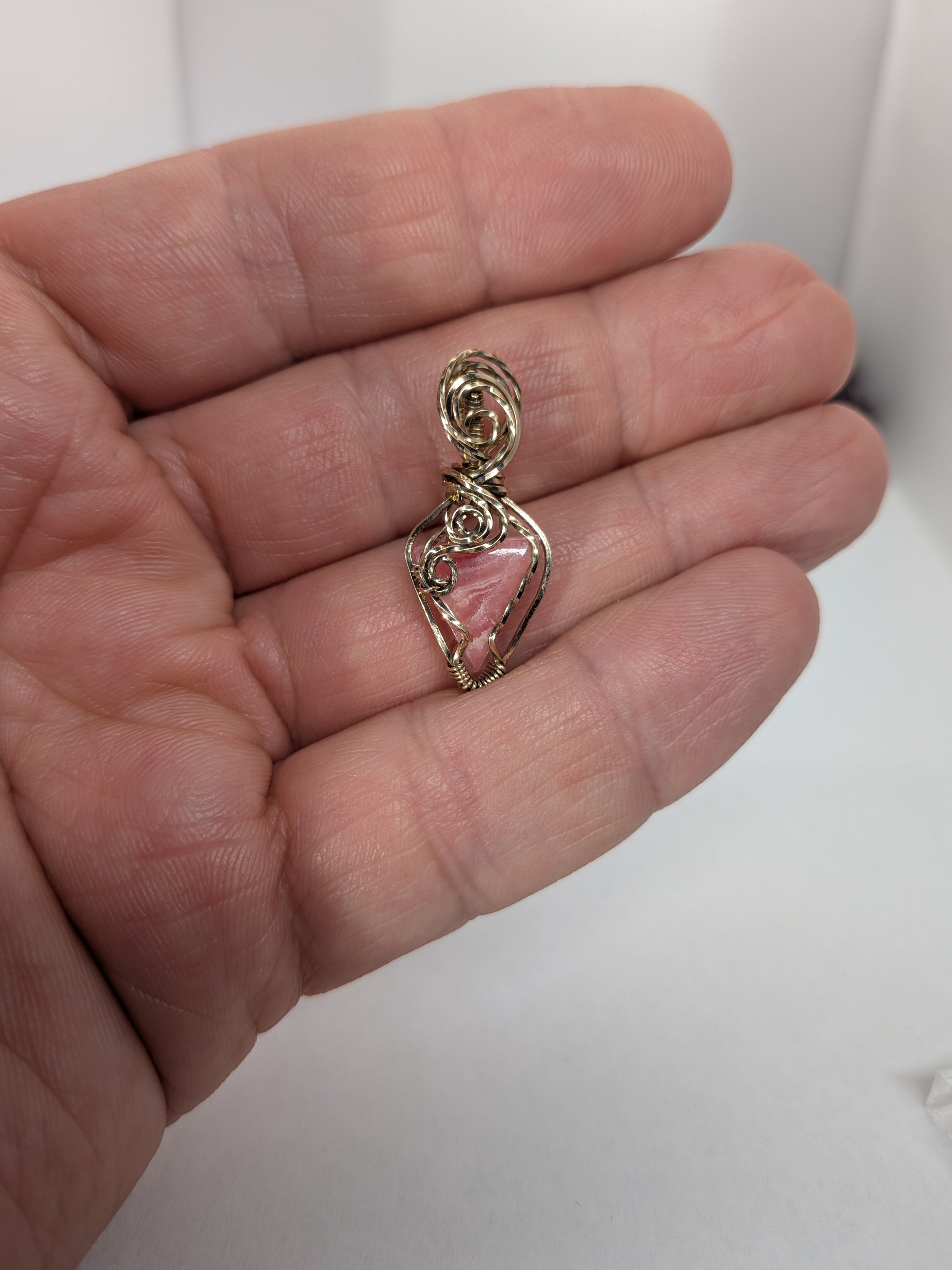 Gorgeous petite gemstone pendant, intricately wire-wrapped and accented with a heart-style bail, beautifully highlighting the stone as the centrepiece.