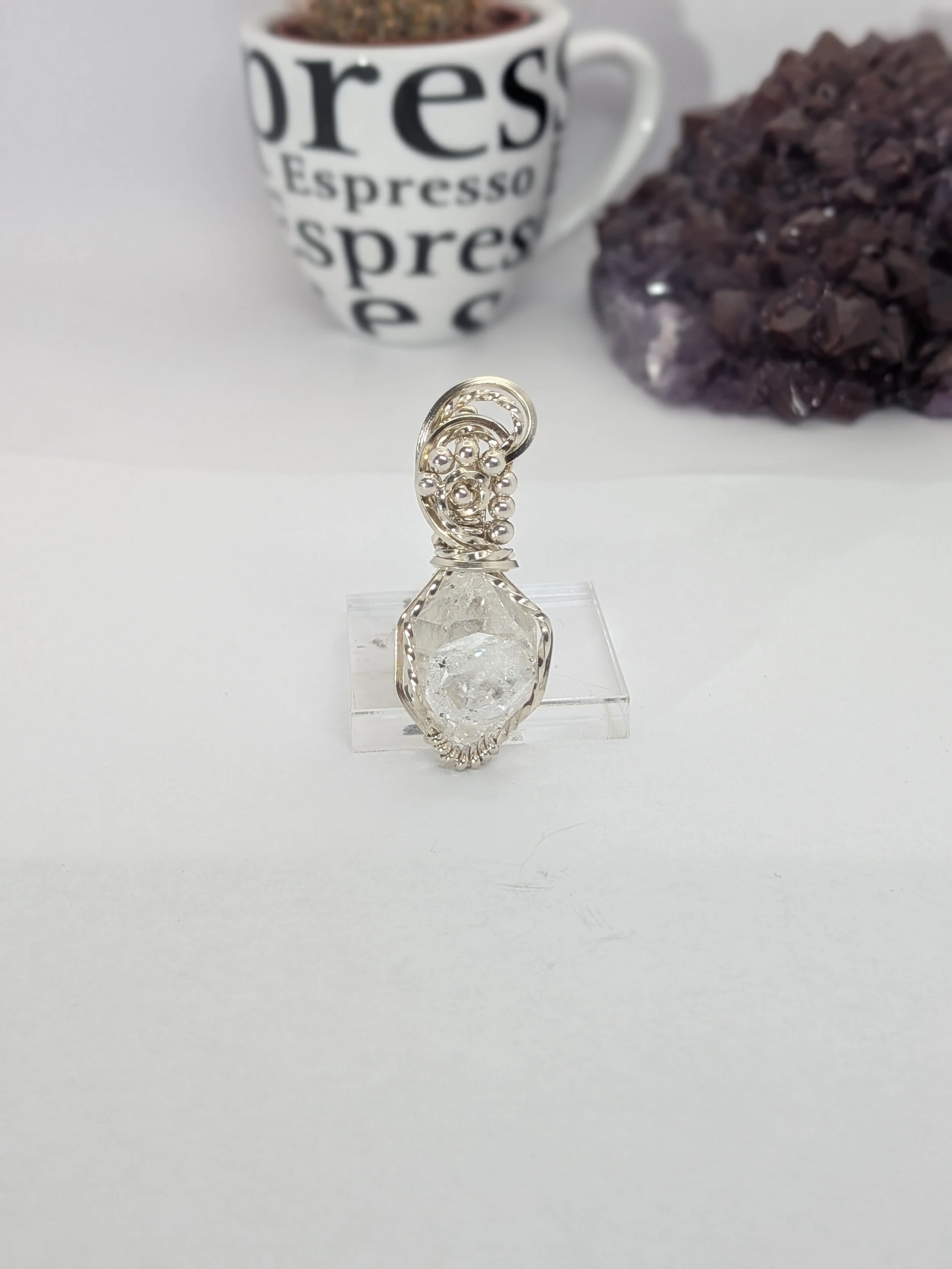 Extra large Herkimer diamond wrapped in antiqued sterling silver wire features an elegant wavy wire bail, with wire twisting and cascading down both sides of the diamond.