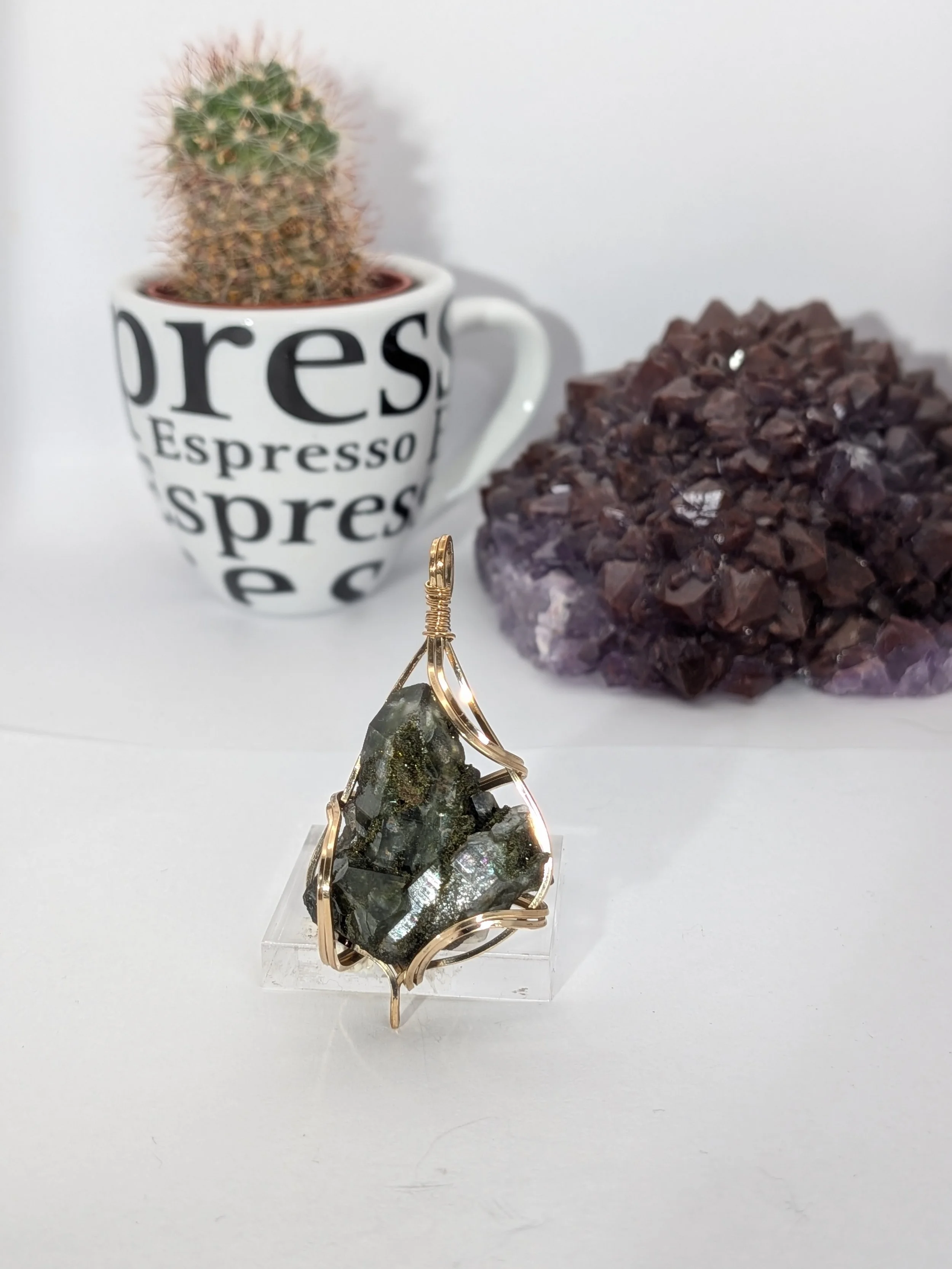 Gorgeous raw epidote, intricately wire-wrapped, beautifully highlighting the stone as the centrepiece.