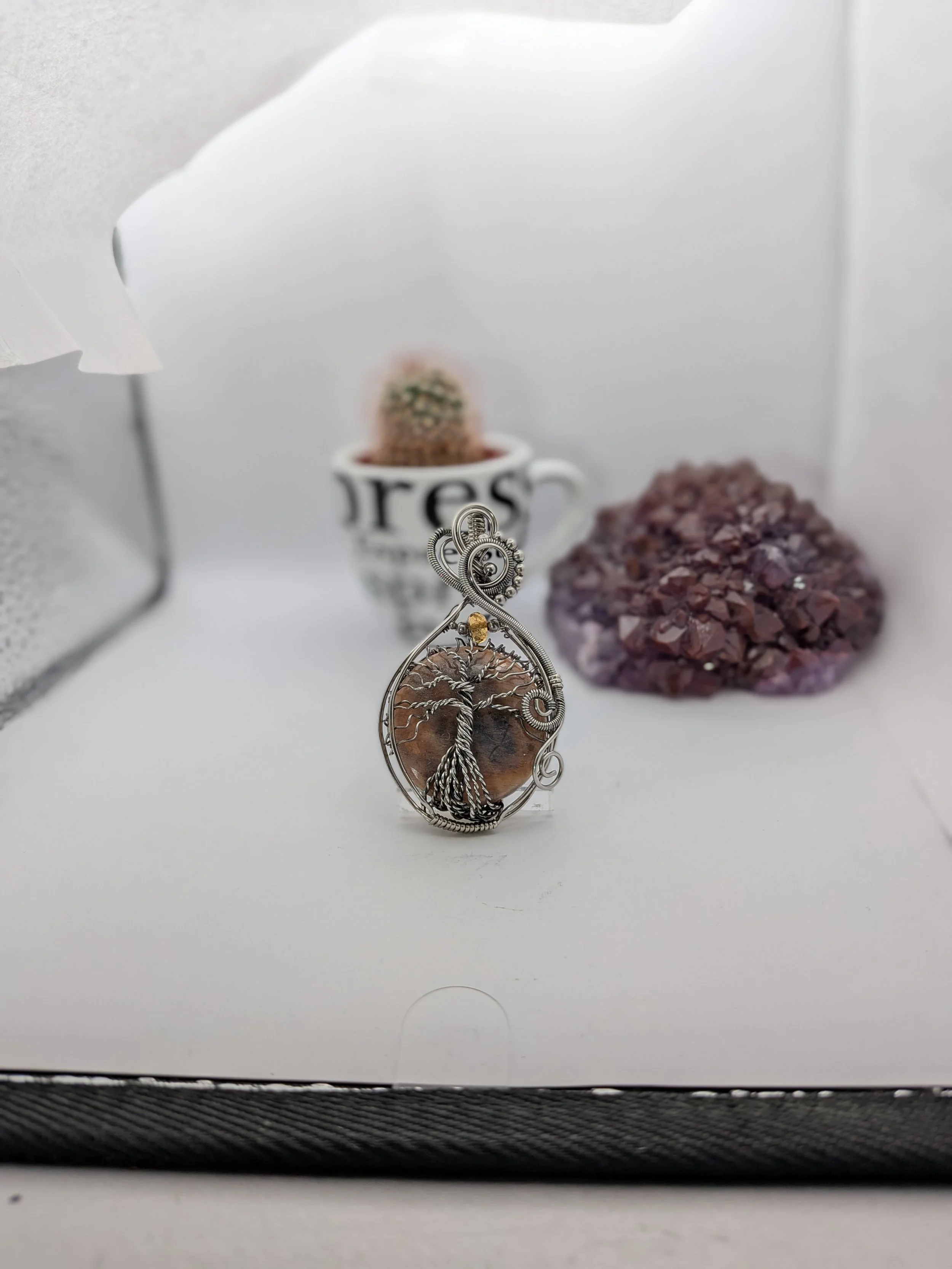 This captivating, stainless wire Black Moonstone tree of life pendant draws you into a stunning forest. Featuring a clean background, this piece offers a beautiful, detailed view on both sides.