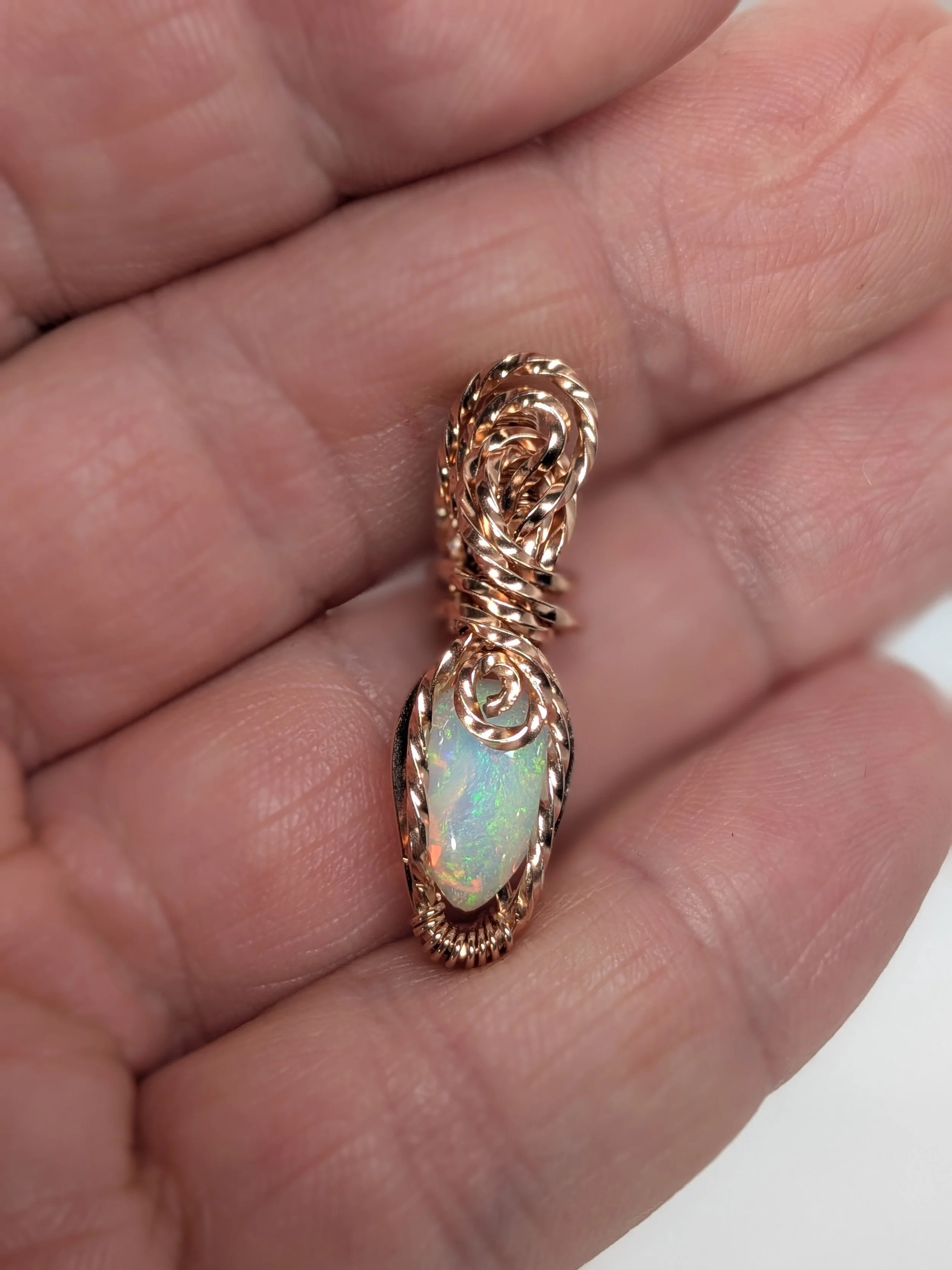 Gorgeous petite gemstone pendant, intricately wire-wrapped and accented with a heart-style bail, beautifully highlighting the stone as the centrepiece.