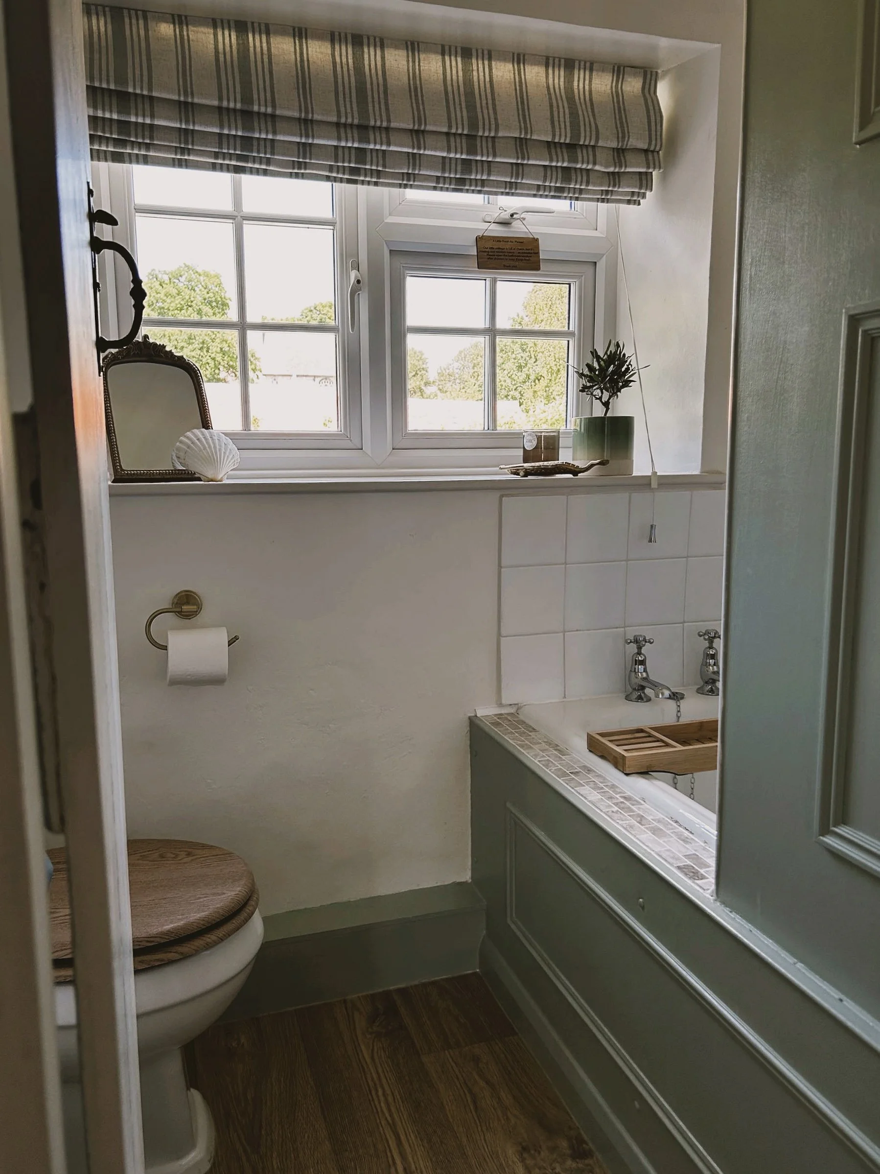 Our quaint and characterful bathroom with shower over bath tub.