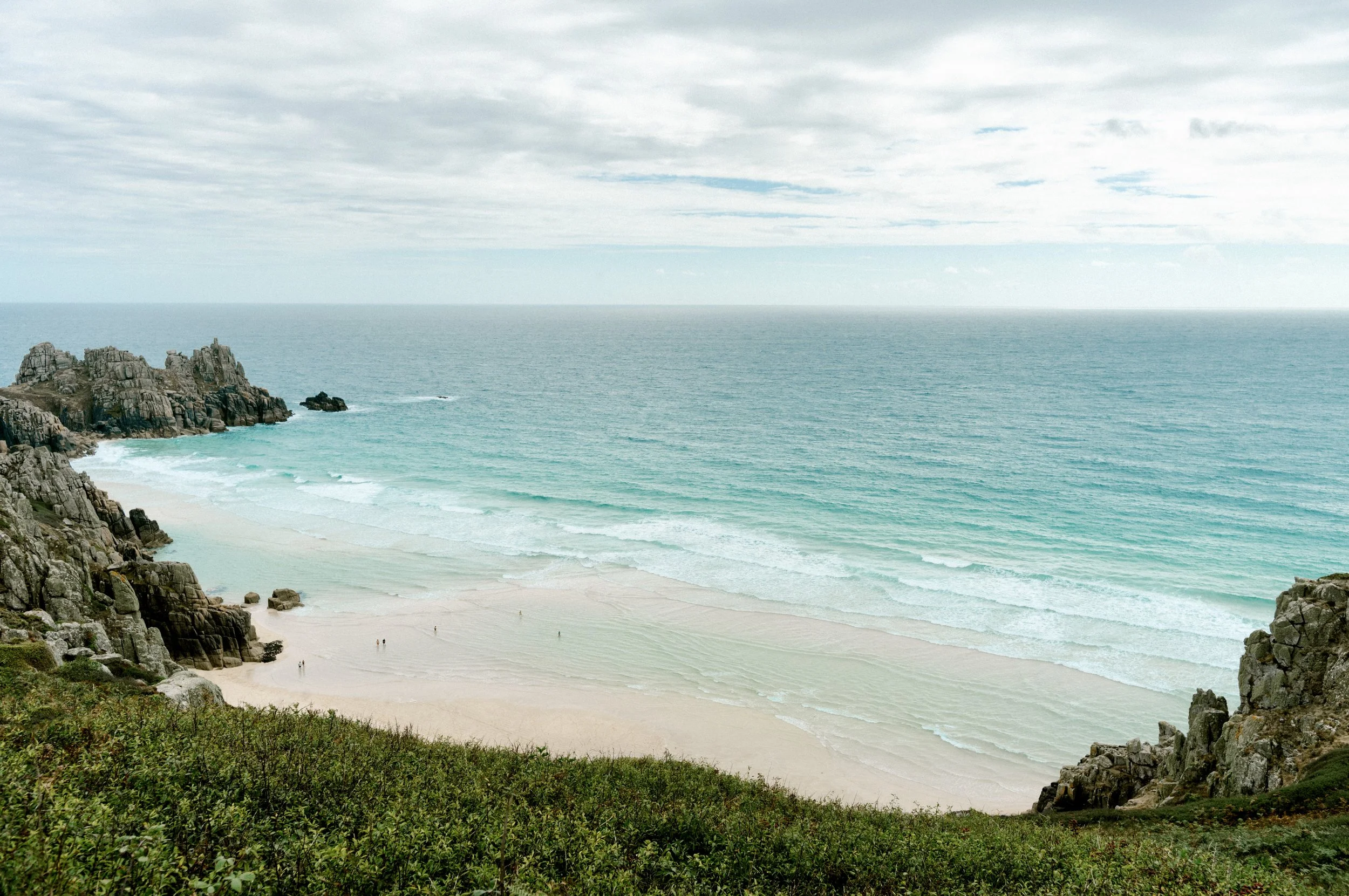 Turquoise sandbar at Pedn Vounder beach from the clifftop at low tide.