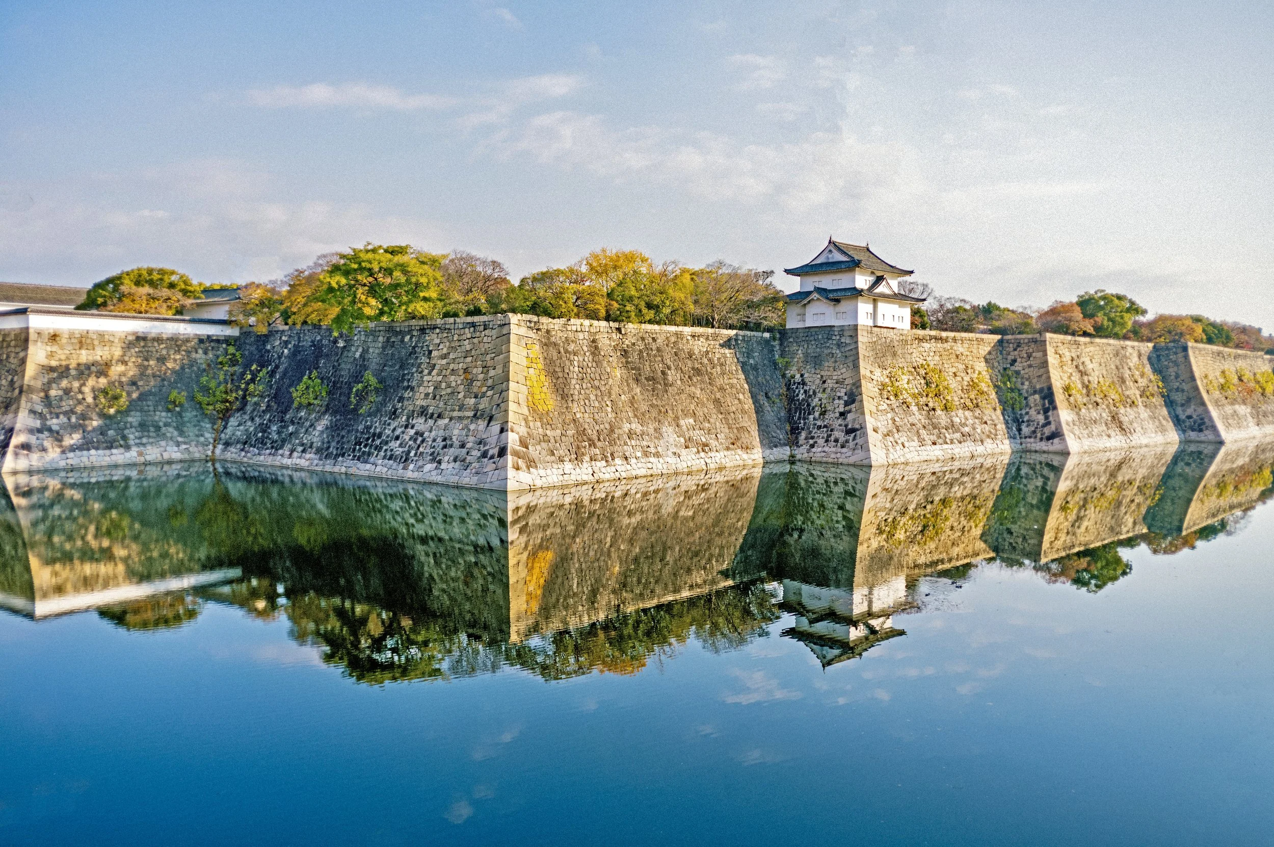Reflection of Osaka Castle Walls in moat water