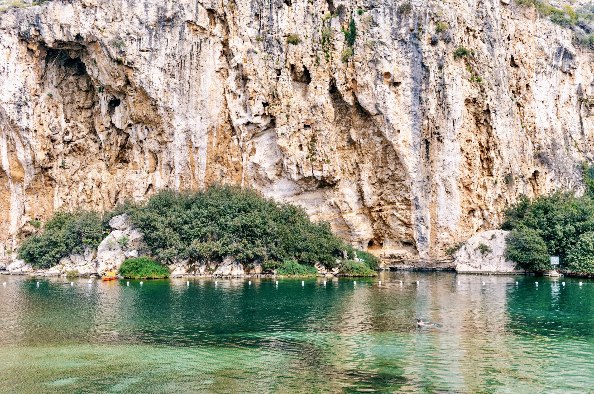 View across Vouliagmeni thermal lake near Athens Greece in afternoon light