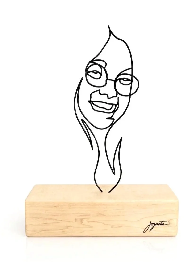 MAY PANG | 12"x14"x3 | 9ft of Single Wire | Maple Base 
Celebrating the vibrant presence of a 21-year-old muse, sculpted like an emerging flame to honor her profound warmth and influence. Inspired by a portrait by the iconic photographer behind Abbey