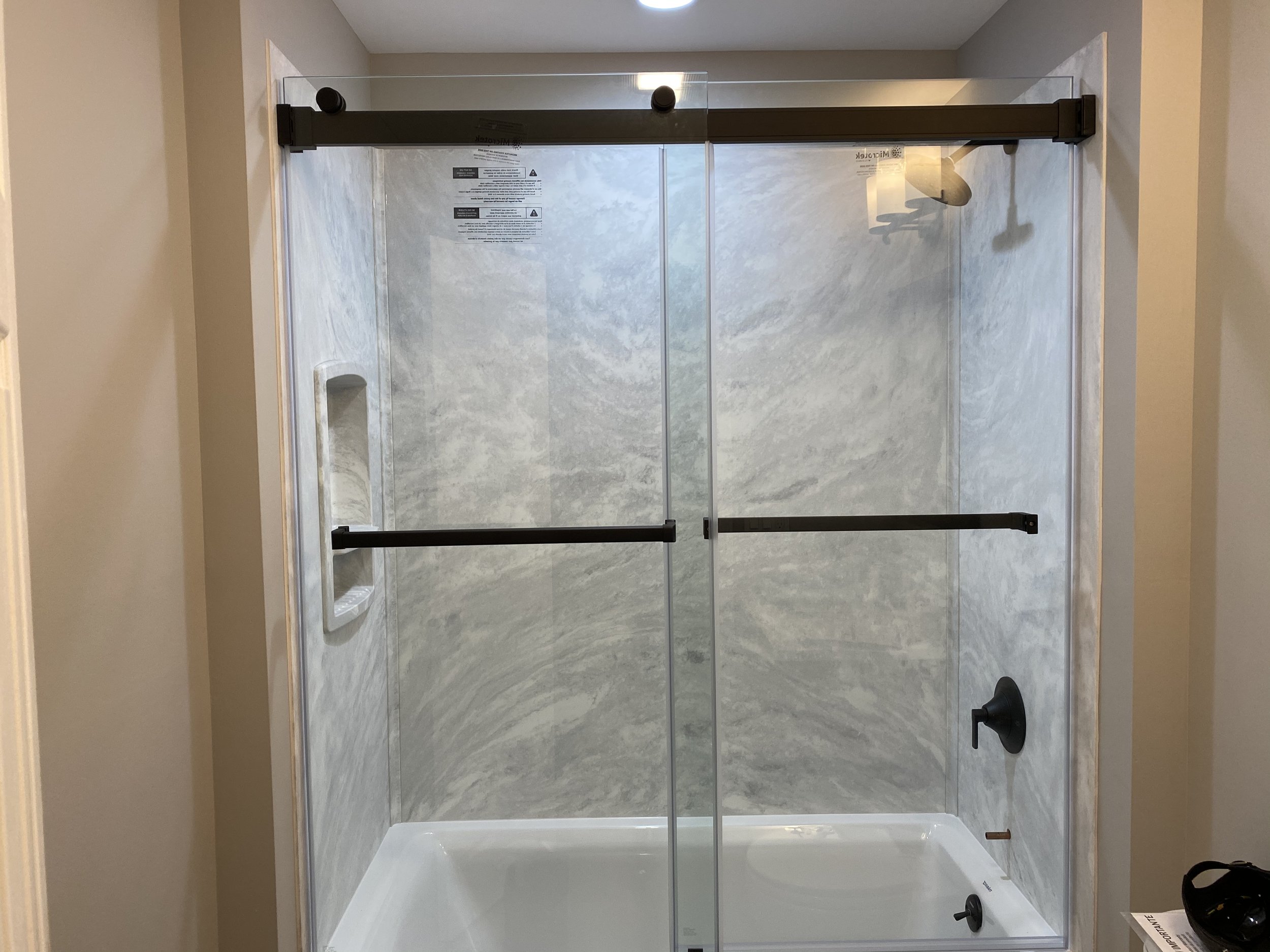 Swanstone tub walls with frameless bypass door