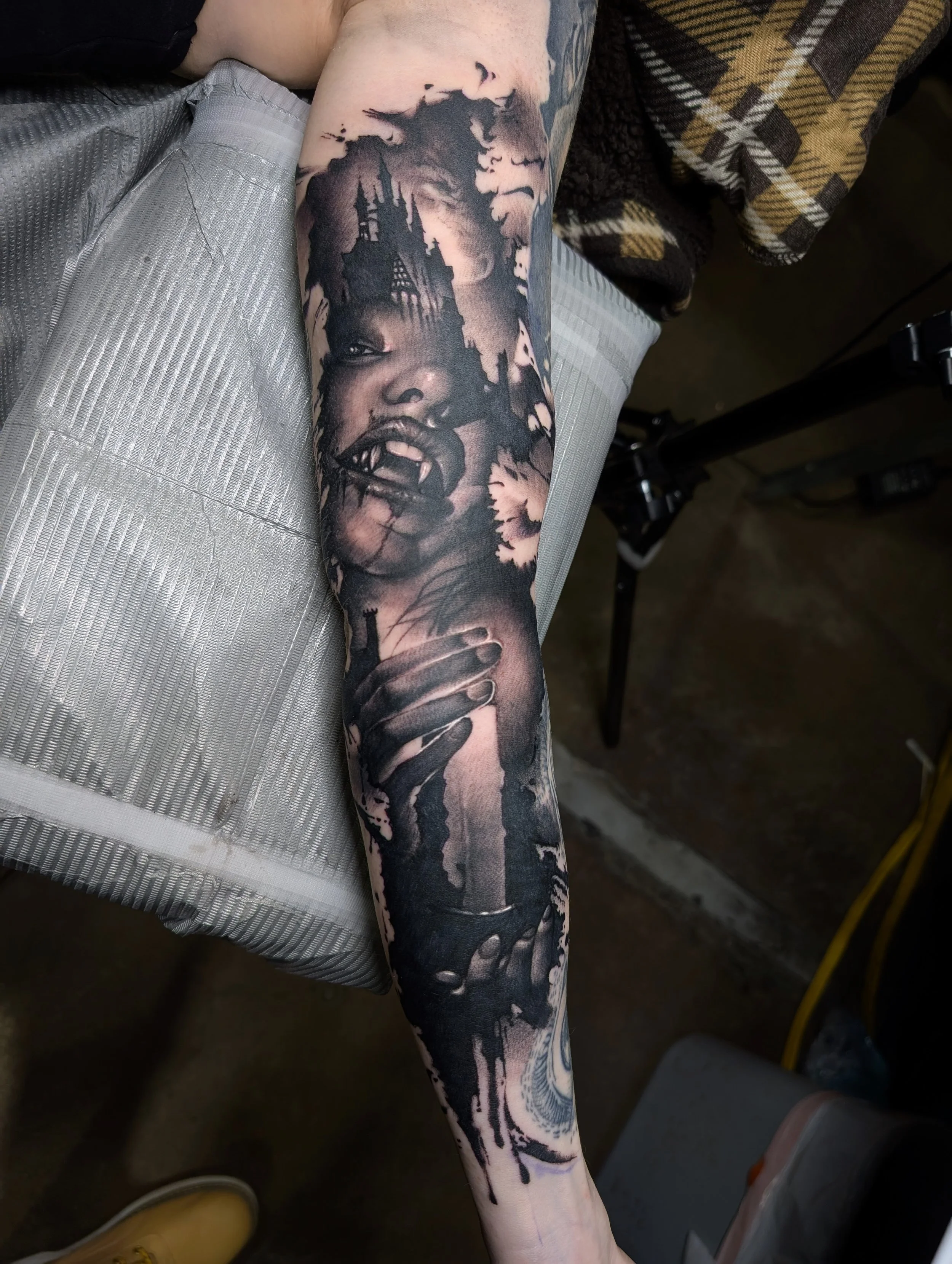 black and grey realism tattoo of a female vampire holding a candle