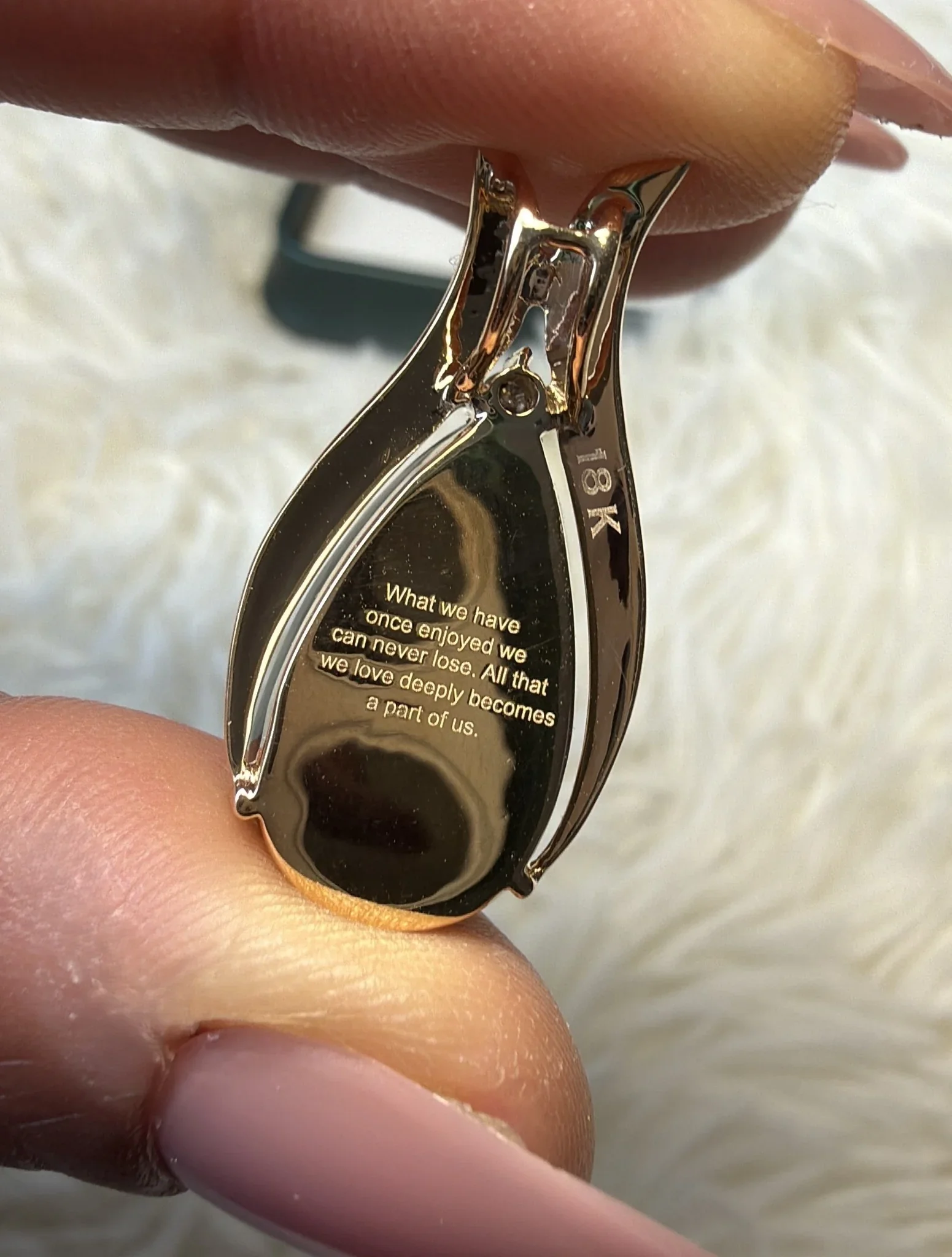 Close-up of an 18K gold pendant engraved with a heartfelt message, symbolizing Layaz’s dedication to personalization, sentiment, and fine craftsmanship.