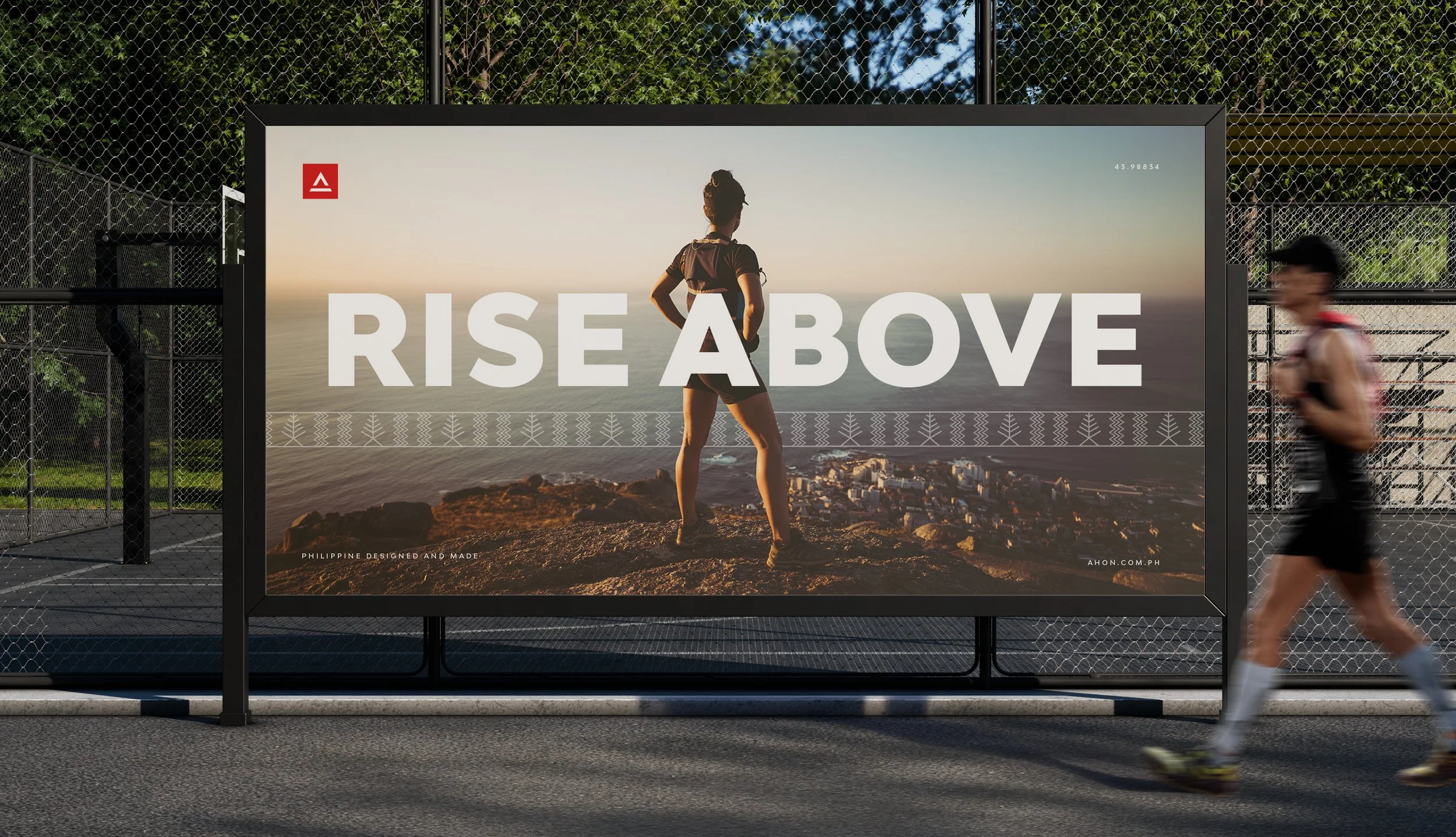 Ahon Rise Above billboard mockup featuring a runner overlooking a mountain landscape and a subtle heritage pattern.