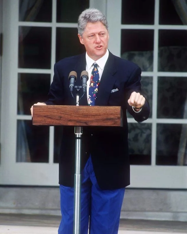In this photo, President Bill Clinton can be seen wearing a tie designed by a 9-year-old girl named Tracy, sold by the non-governmental organization Save the Children.  Clinton wore a number of different ties from this series during his presidency, s