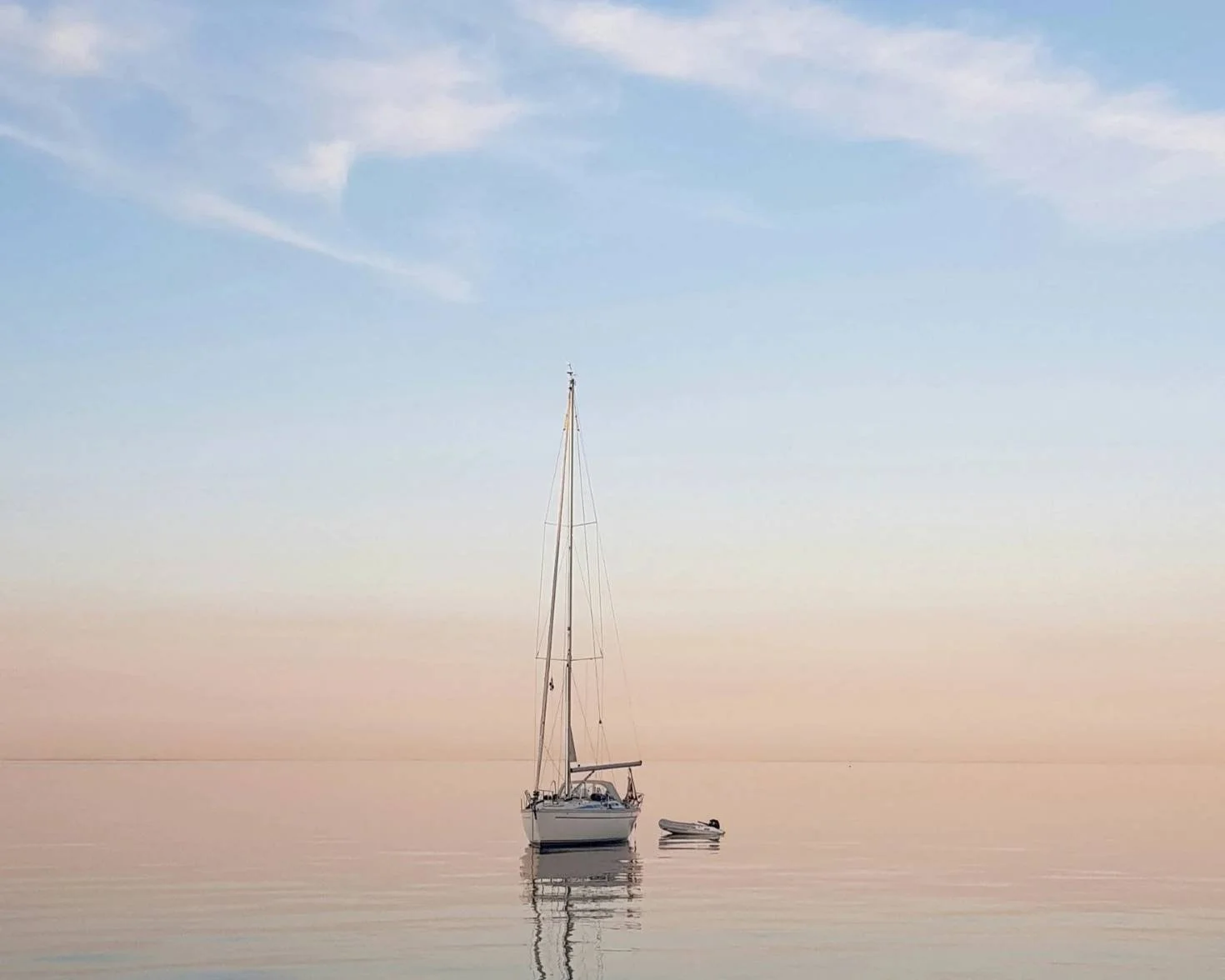 Sailboat on calm waters at dawn