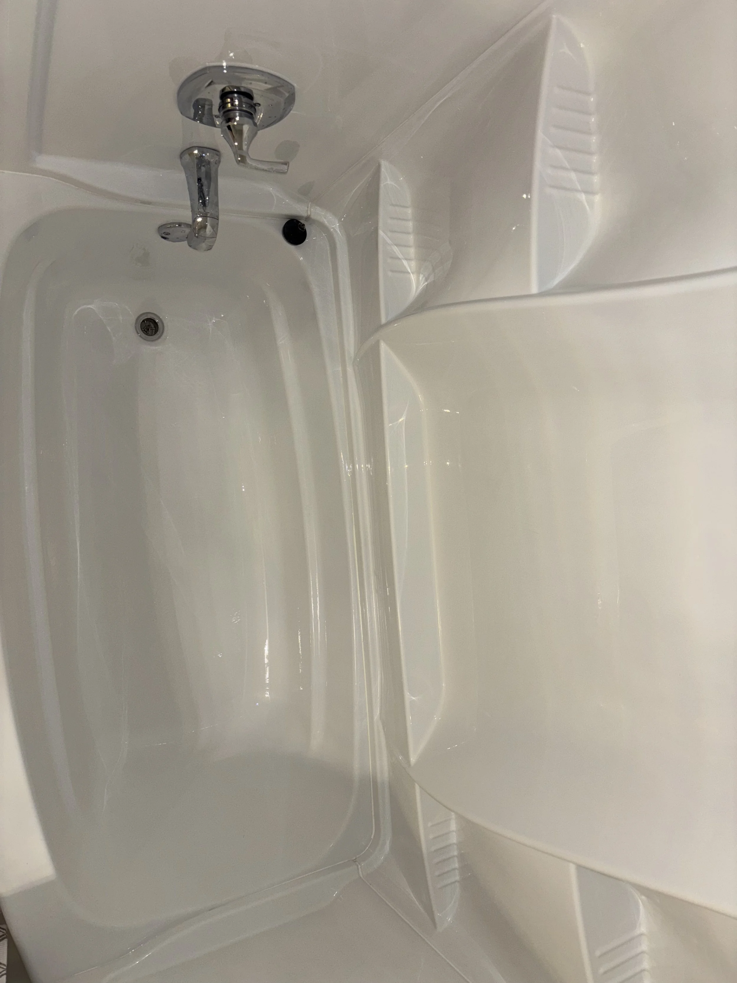 The image shows the interior of a white bathtub completely spotless after removed buildup dirt and grime.  