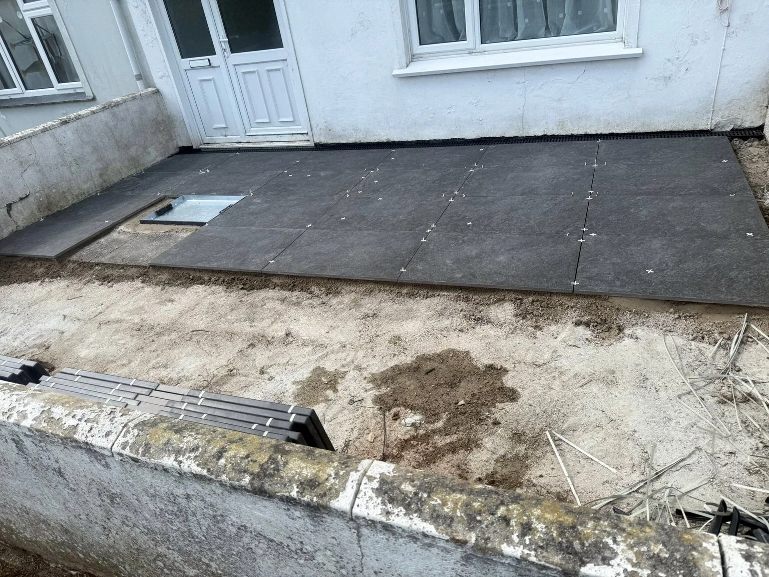 Getting there with this patio tidy up and re-lay 👍

Old slabs out, levels sorted, new tiles going down.

Still looks like a building site round the edges mind 😅

But it&rsquo;ll make a massive difference once it&rsquo;s all finished off properly 🌿