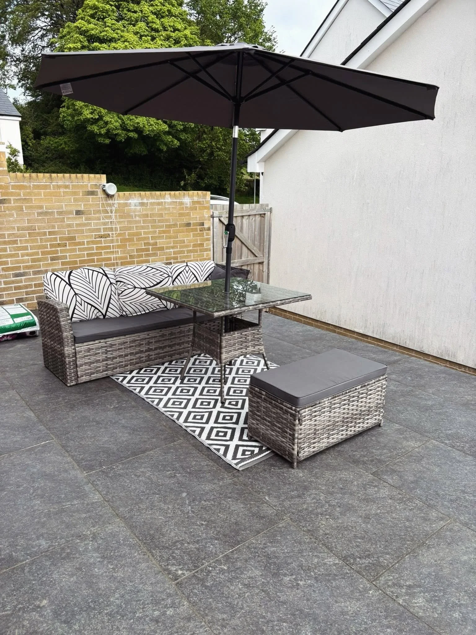 Modern porcelain patio completed by M.L. Rashleigh & Son, creating an outdoor seating area for a family garden in Cornwall.