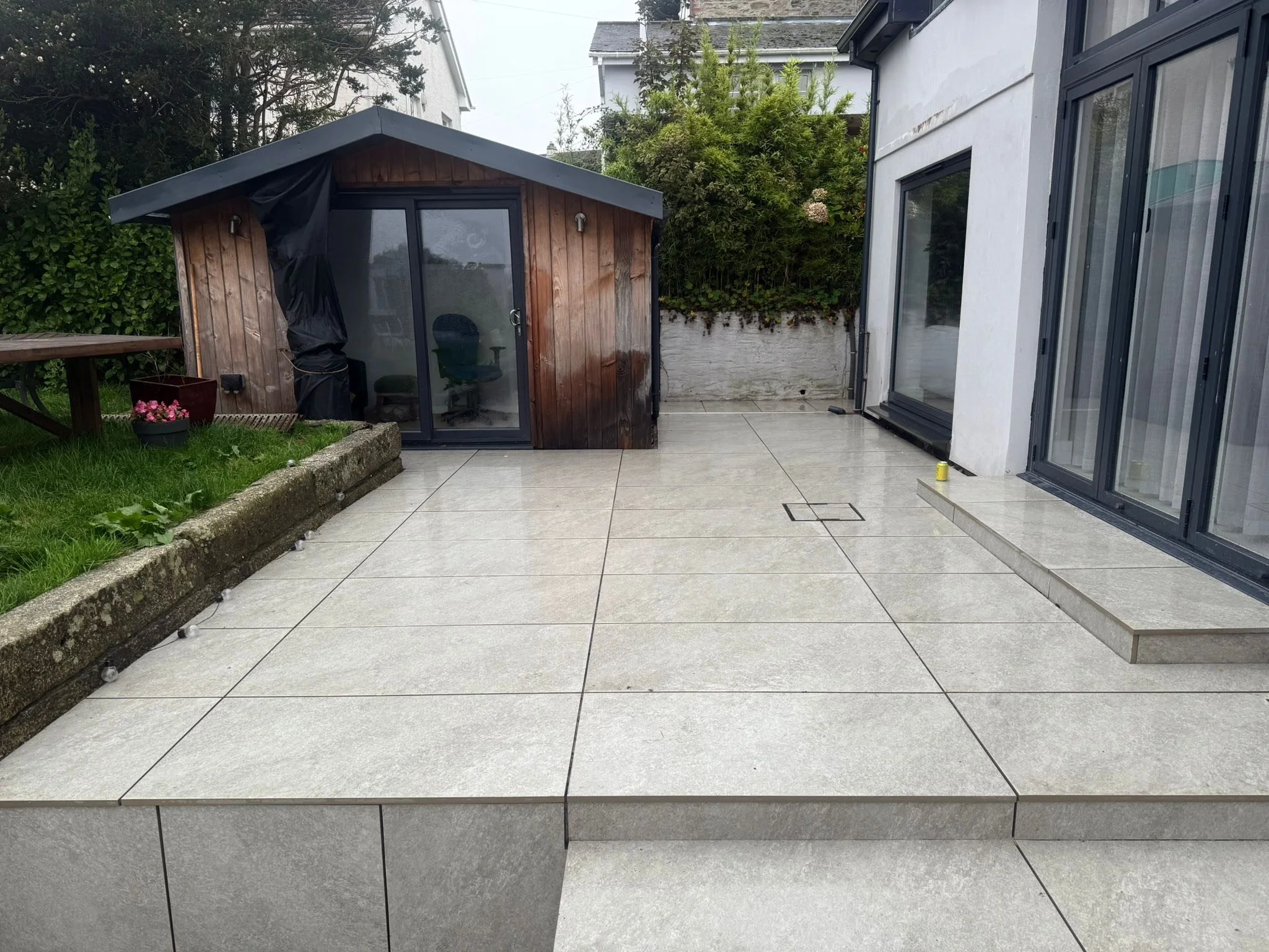 Completed patio install in Cornwall, grey porcelain, clean lines.