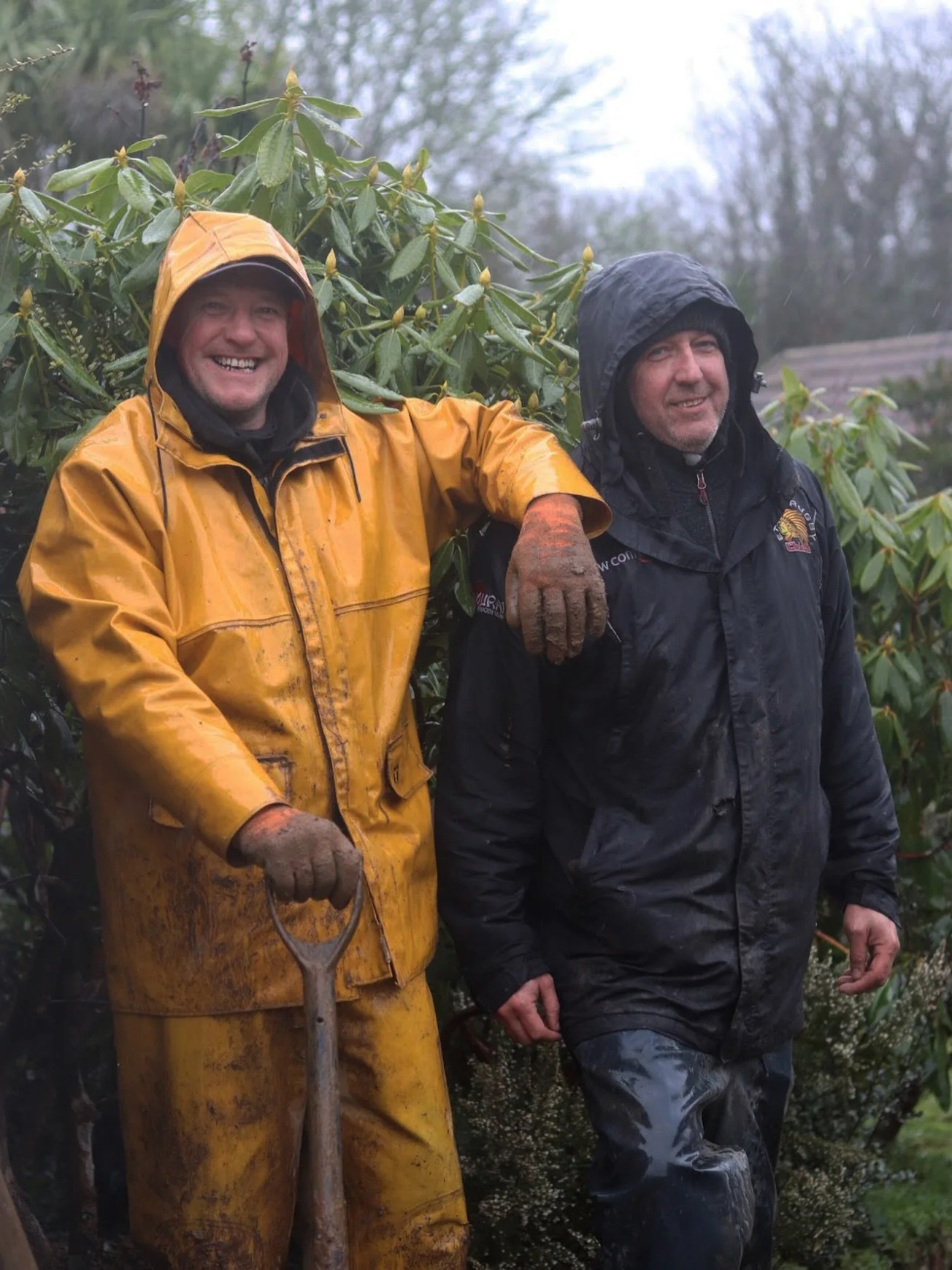 Landscape gardeners working in wet weather on a garden project in Cornwall