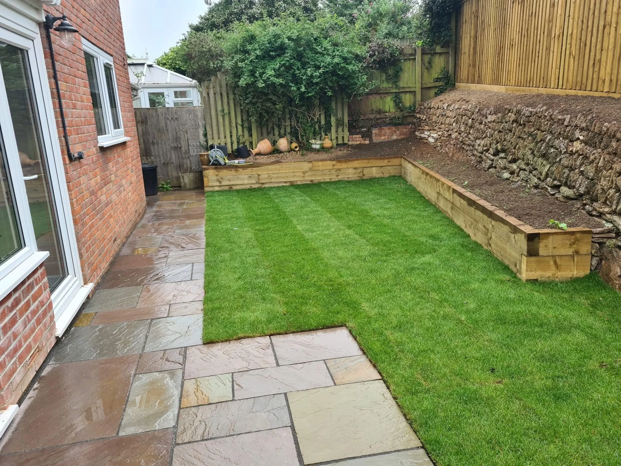 Landscaped Cornish garden with new lawn, paving and timber raised beds