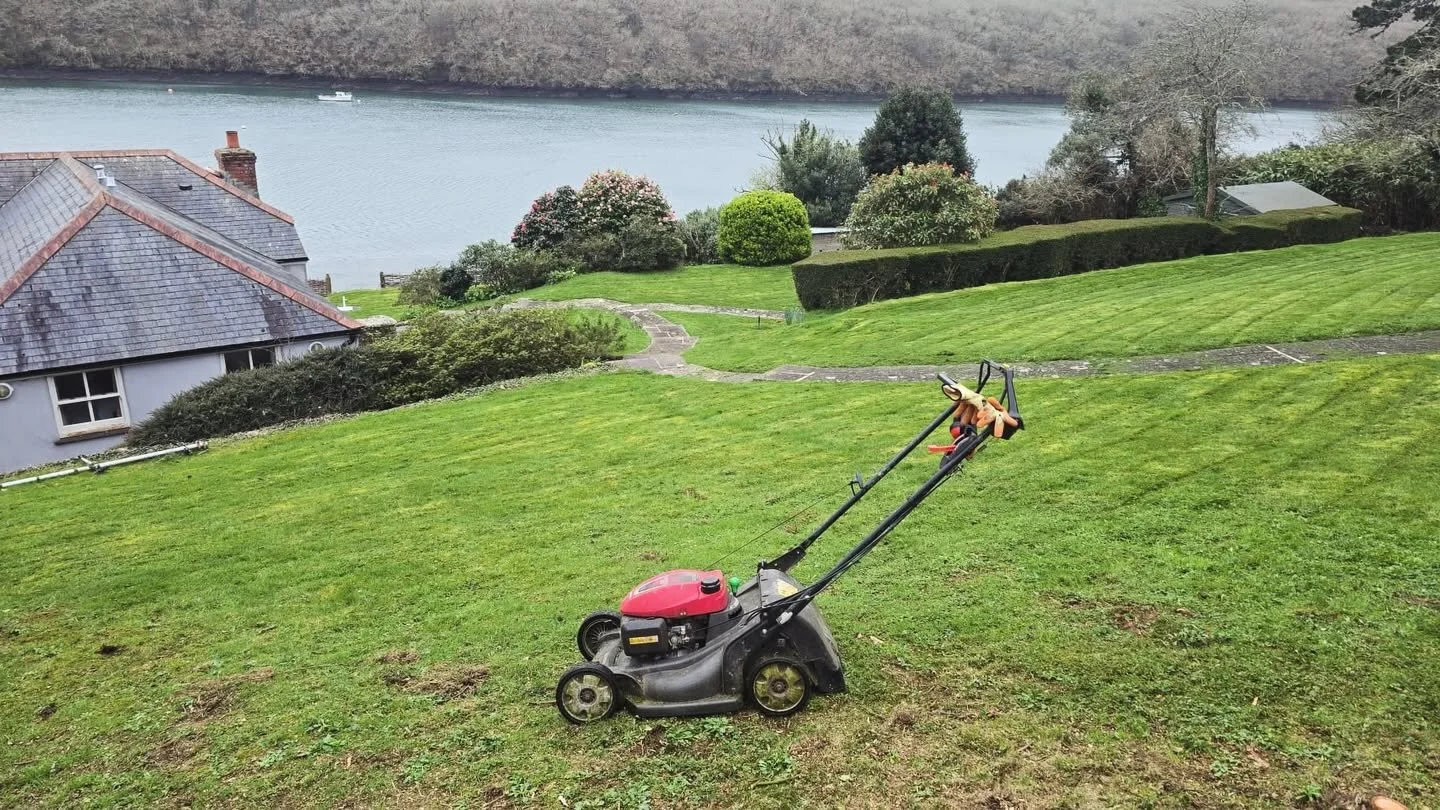 1. Sloping Cornish garden overlooking the water with a large lawn being maintained