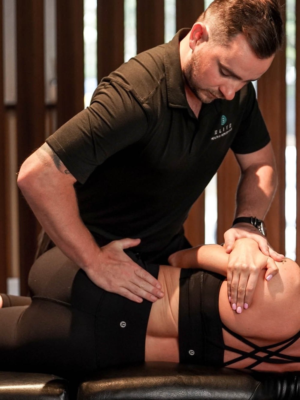 Brisbane physiotherapist performing joint adjustment treatment.