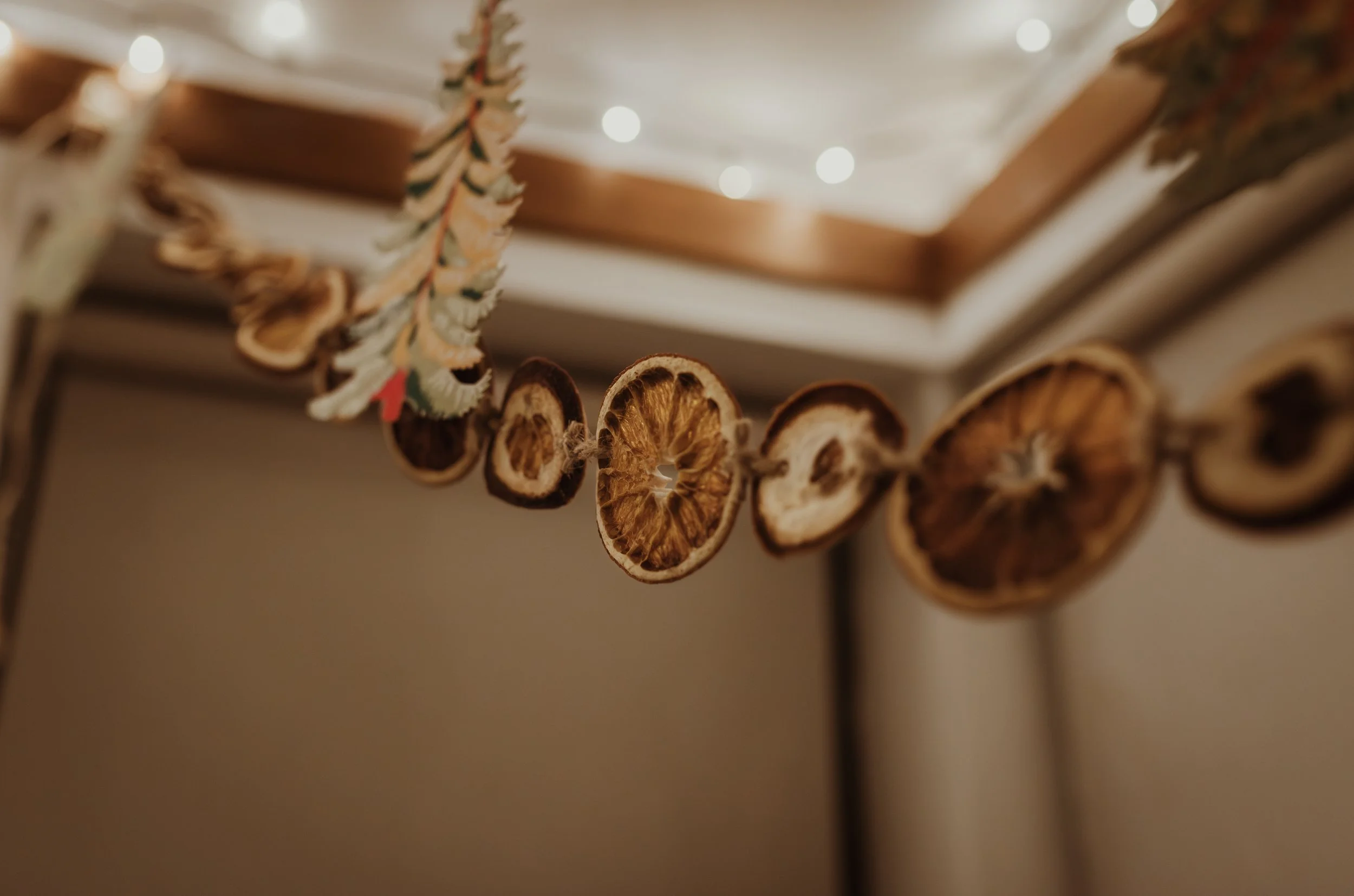 Homemade dried orange garland decorating the home during a Glasgow home birth in December, filling the room with the warmth of Christmas