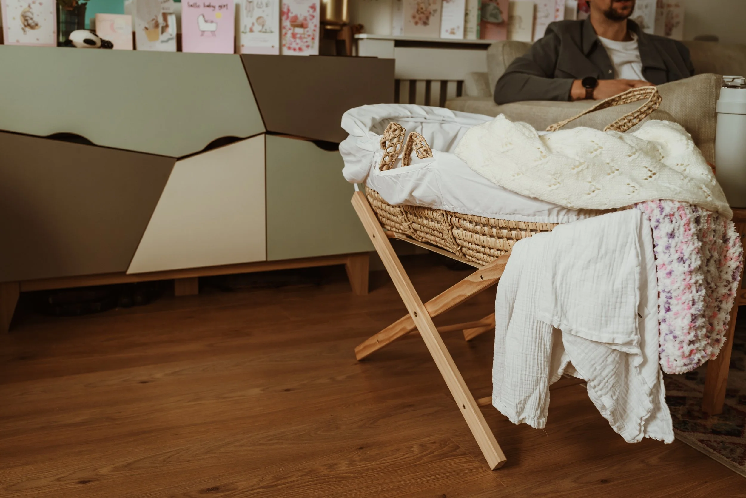 Beautifully prepared moses basket with white linen in a nursery, documented during an at-home newborn photography session in Glasgow with Marieke Captures Birth