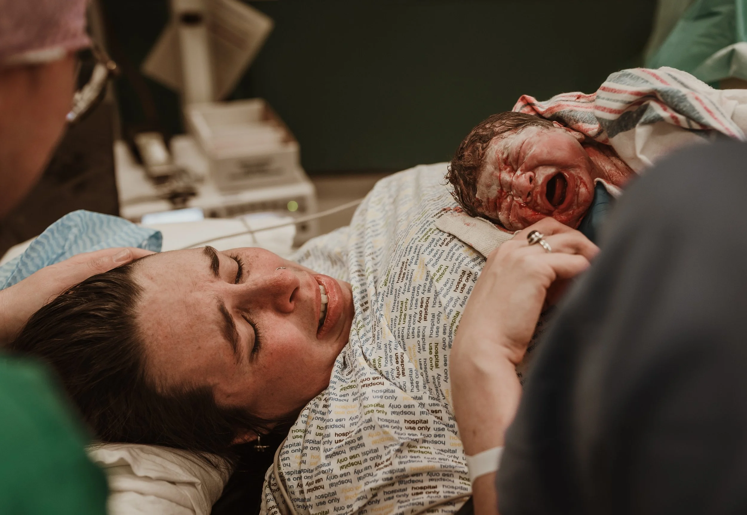 Birth photographer Scotland capturing mother holding newborn during golden hour after labour