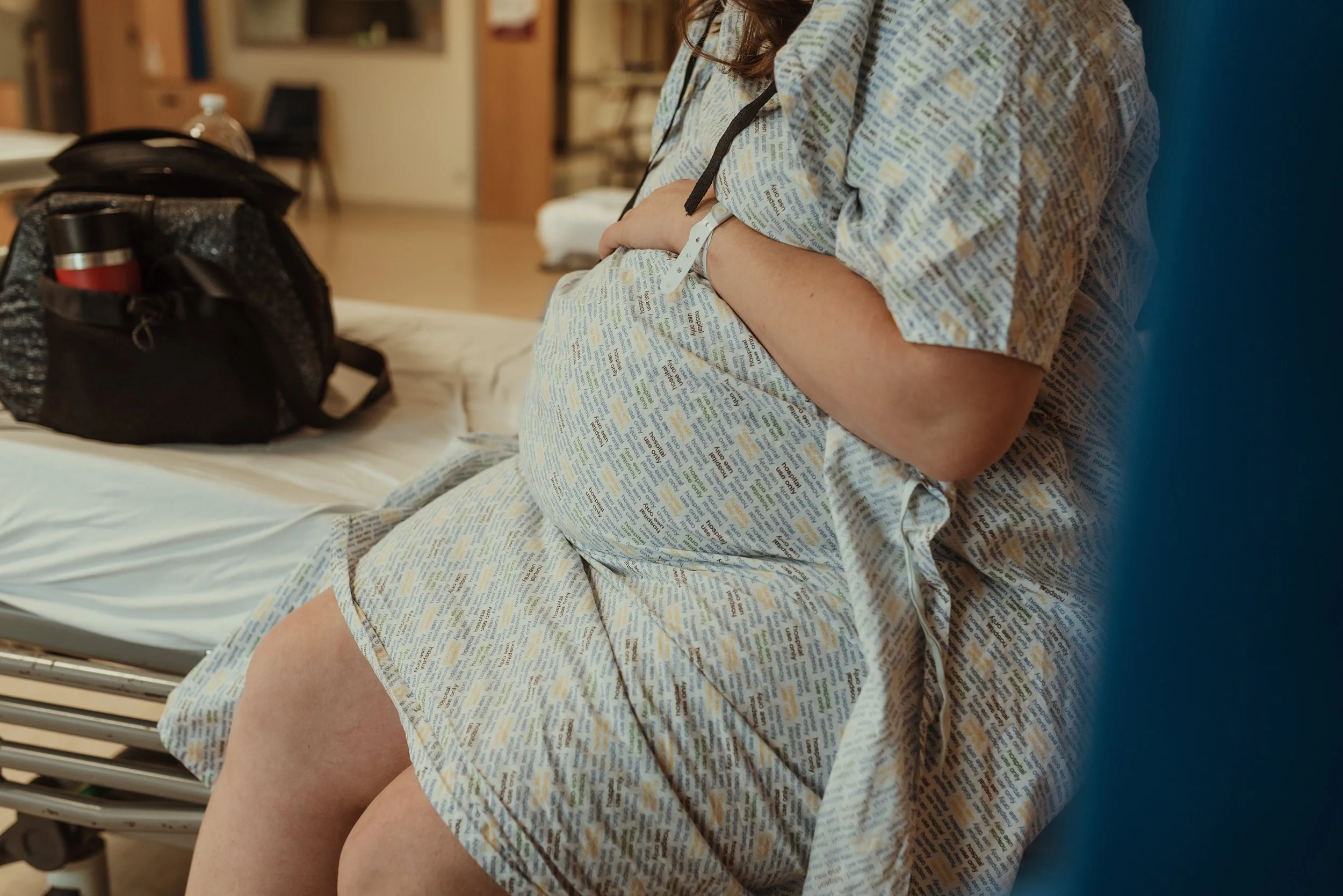 Mother in hospital gown at Princess Royal Maternity Hospital Glasgow shortly before her elective caesarean birth, photographed by Glasgow birth photographer