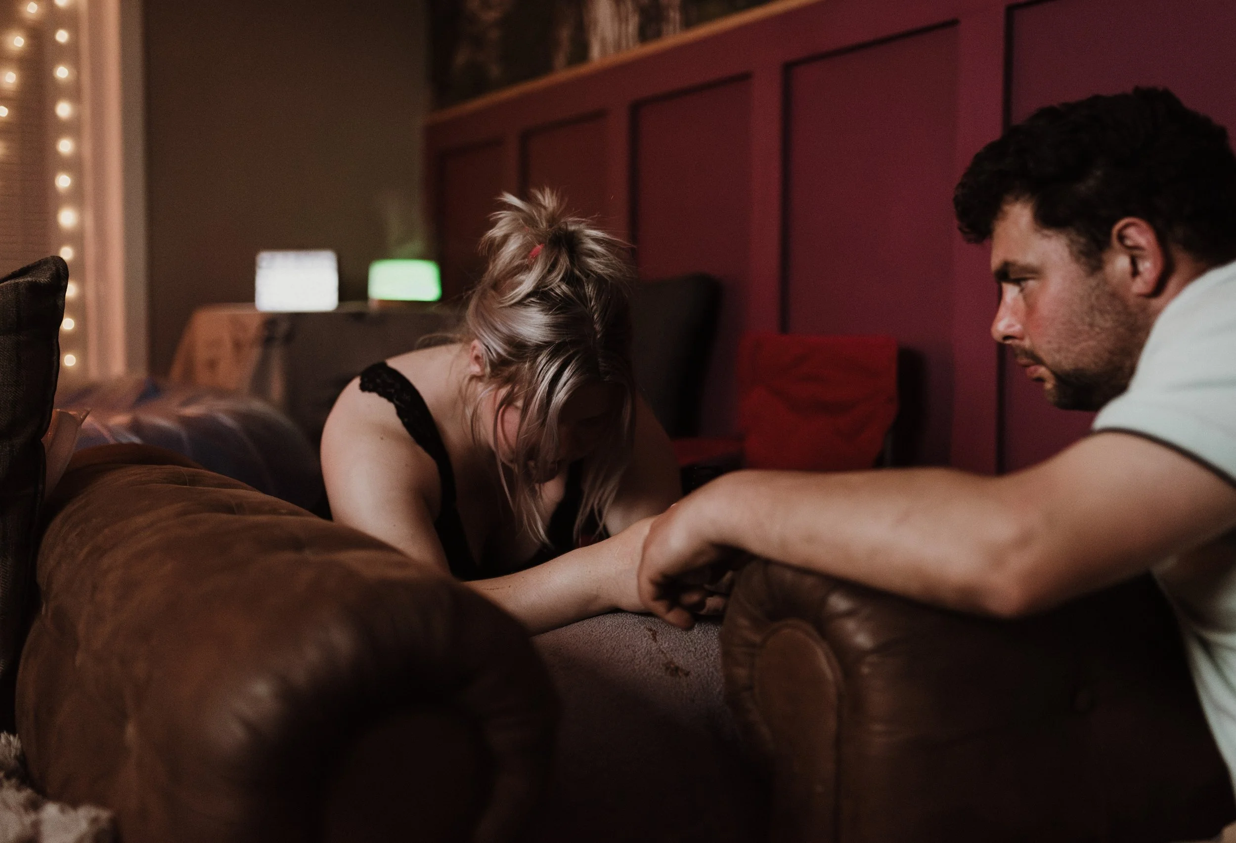 Partner supporting mother during home birth in Scotland photographed by professional birth photographer