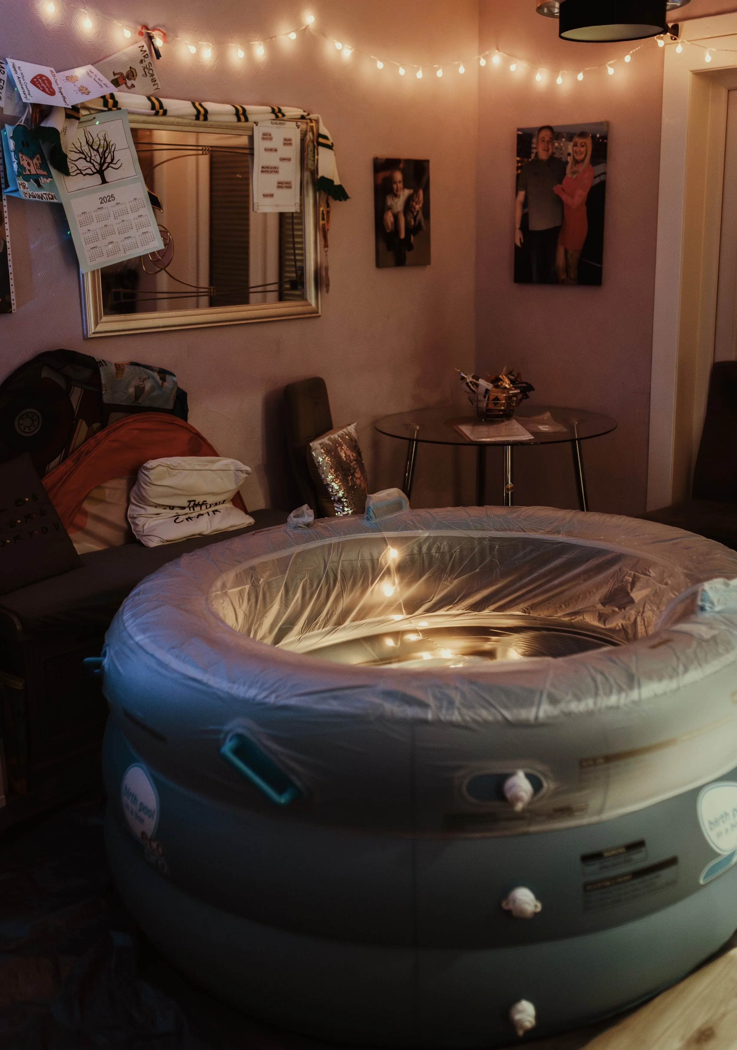 Birth pool lit with fairy lights in a living room, set up for a home birth in Largs