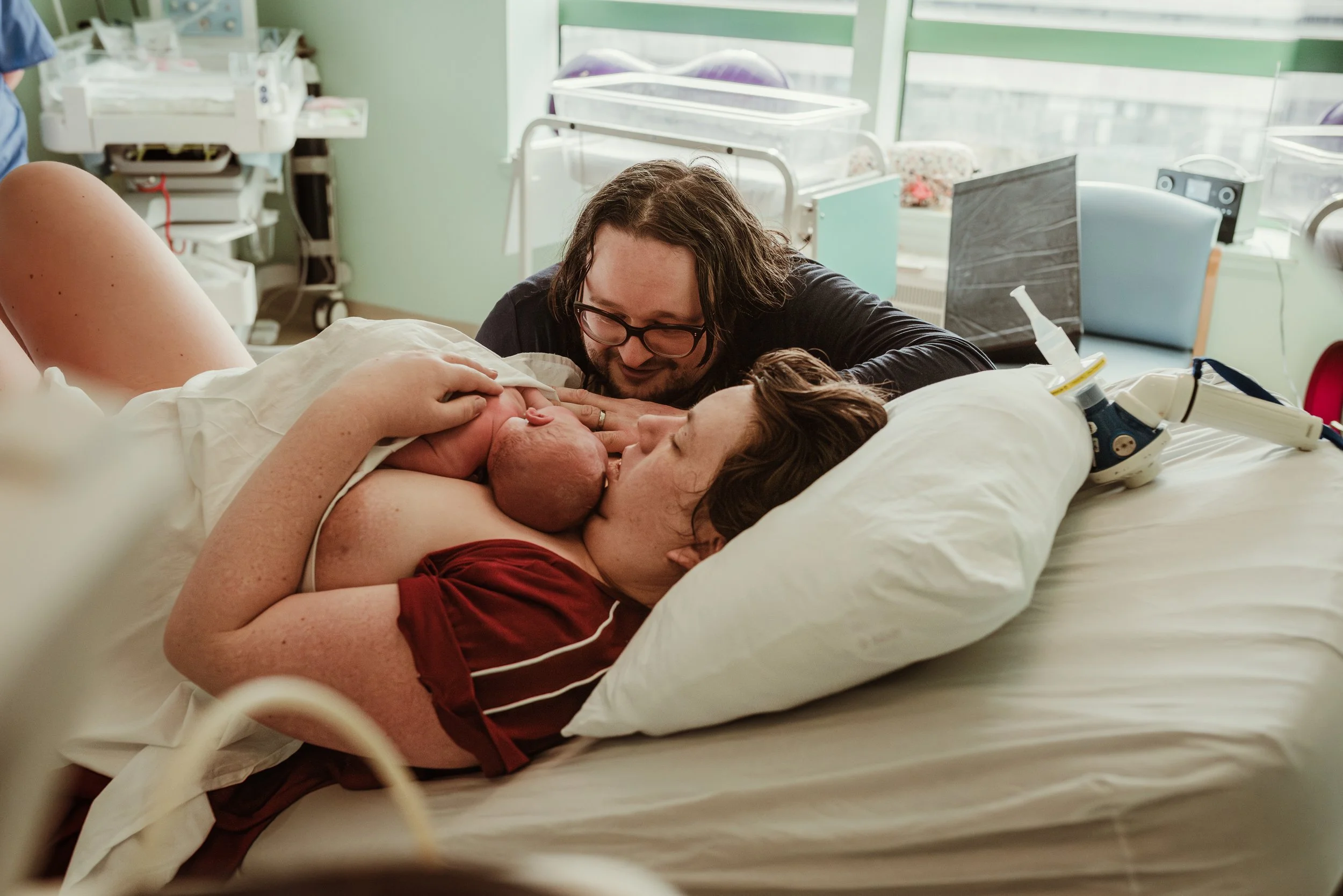 Jenn holding newborn baby Robin on her chest in the golden hour after a swift hospital birth at Princess Royal Maternity Hospital Glasgow