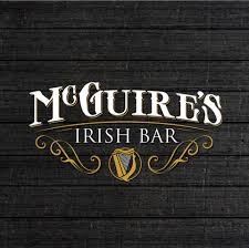 McGuire's Irish Bar logo on a dark wooden background