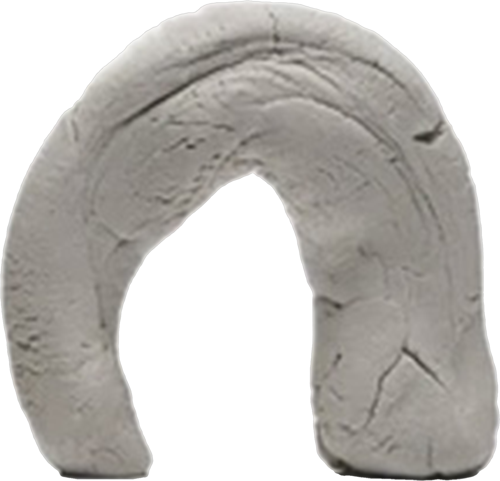 Close-up of a gray clay ring with carved patterns.