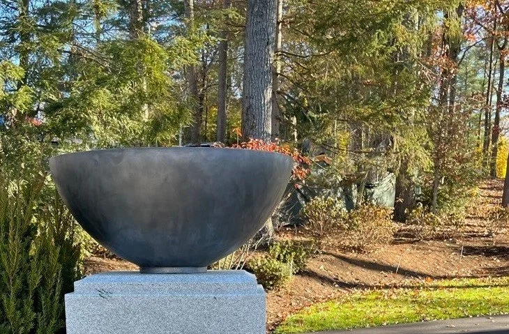 Captured in its element: the Carleton Bowl.

There is a unique architectural strength in seeing this piece perched atop a clean stone plinth. Its wide, sweeping silhouette creates a bold focal point that commands attention without overwhelming the na