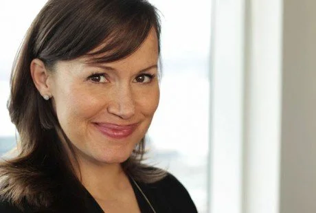 Suzanne Paxton is a five-time Emmy award-winning producer and founder of Point Studio. A woman with medium-length brown hair smiling at the camera, indoors with a window in the background.