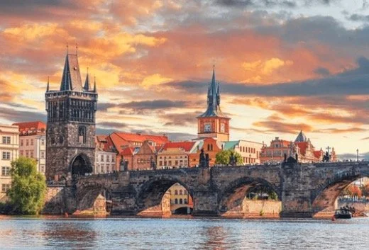 Charles Bridge and Old Town architecture with sunset sky in Prague, Czech Republic.