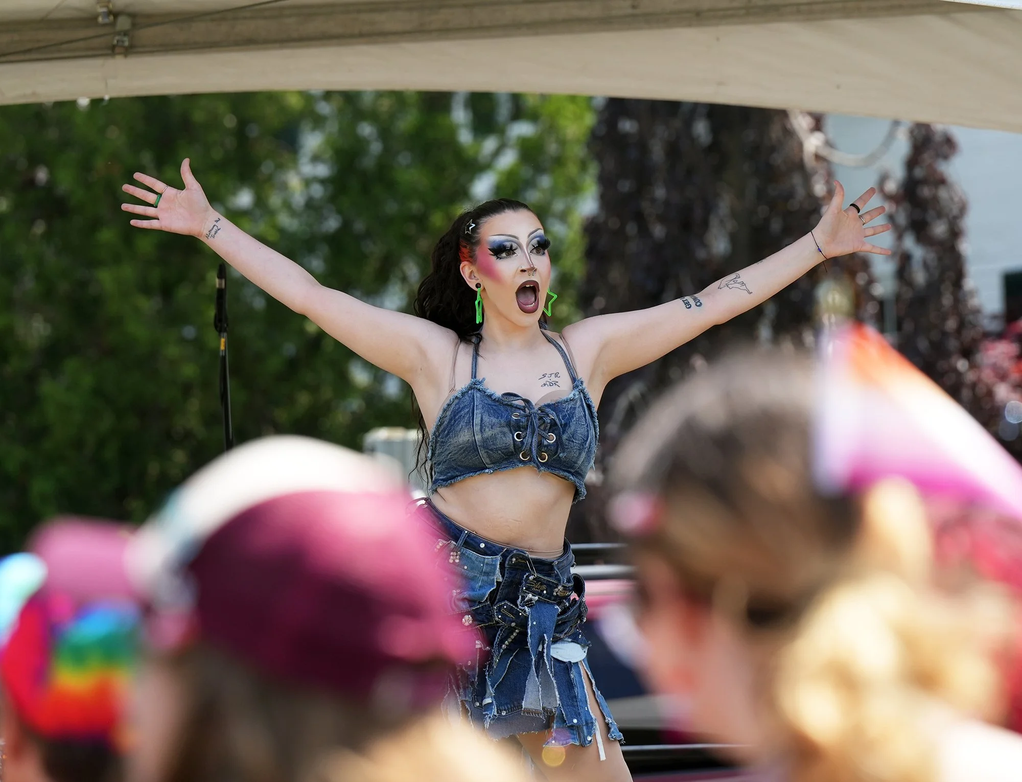 A drag queen hypes on the crowd on stage.