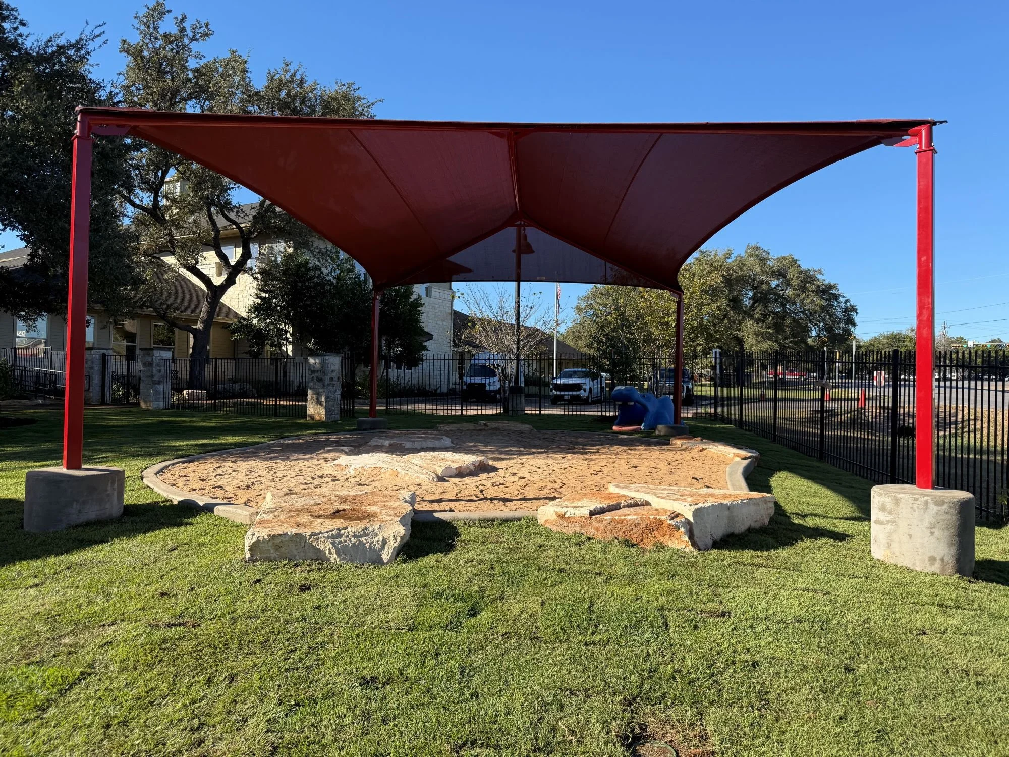Sand play area at outdoor learning space at westbank community library in austin texas, library landscape and exteriorrenovation