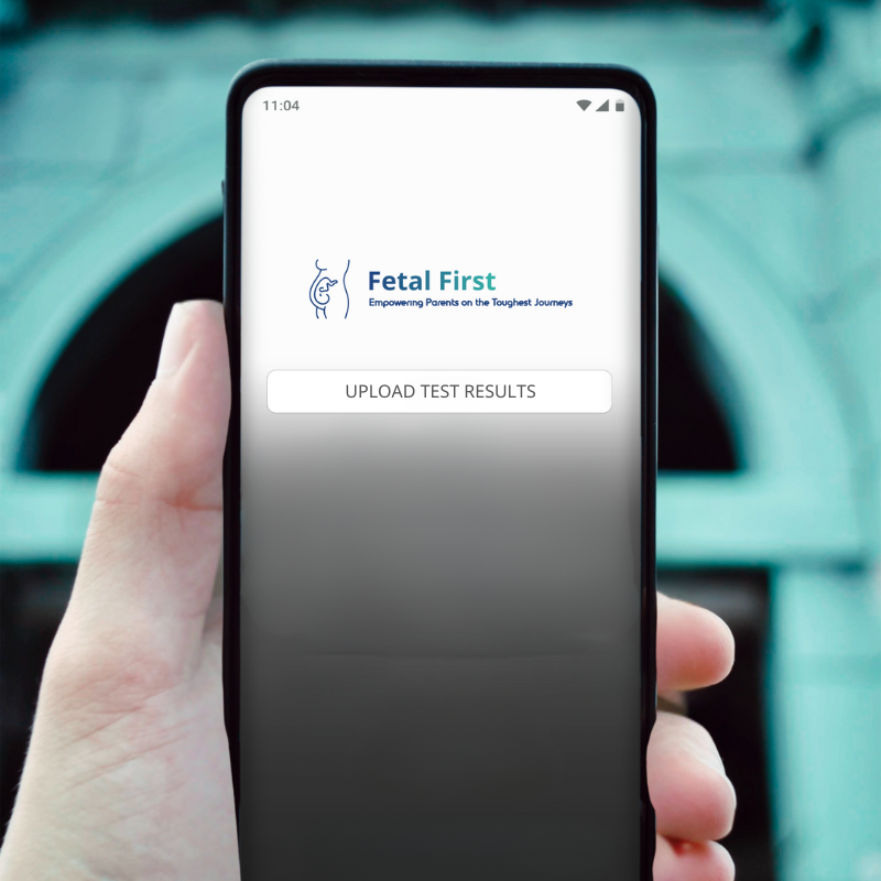 A smartphone screen showing the "Fetal First" app with a logo and an "Upload Test Results" button.