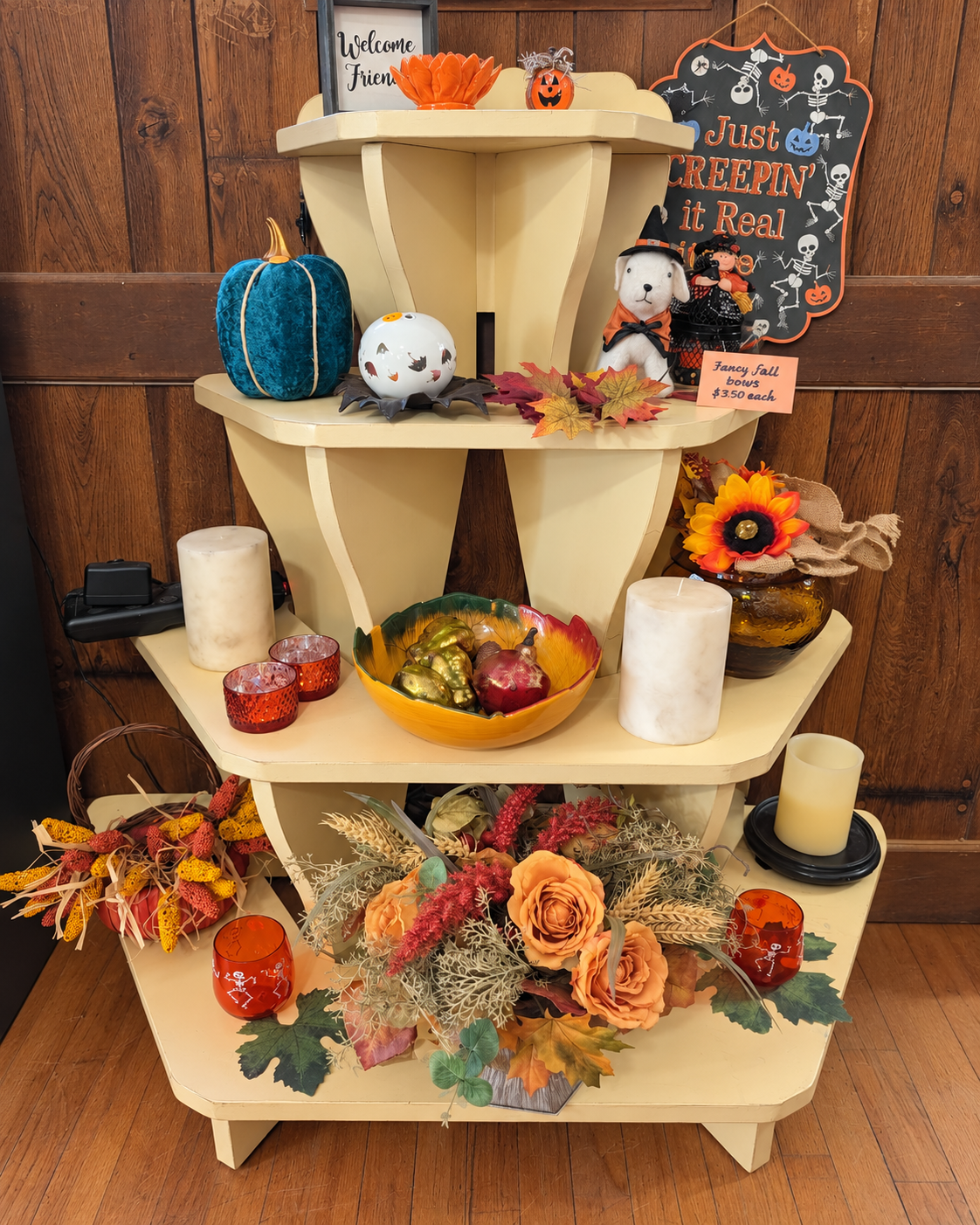 Fall and Halloween decorations on a cream shelf at ECCO