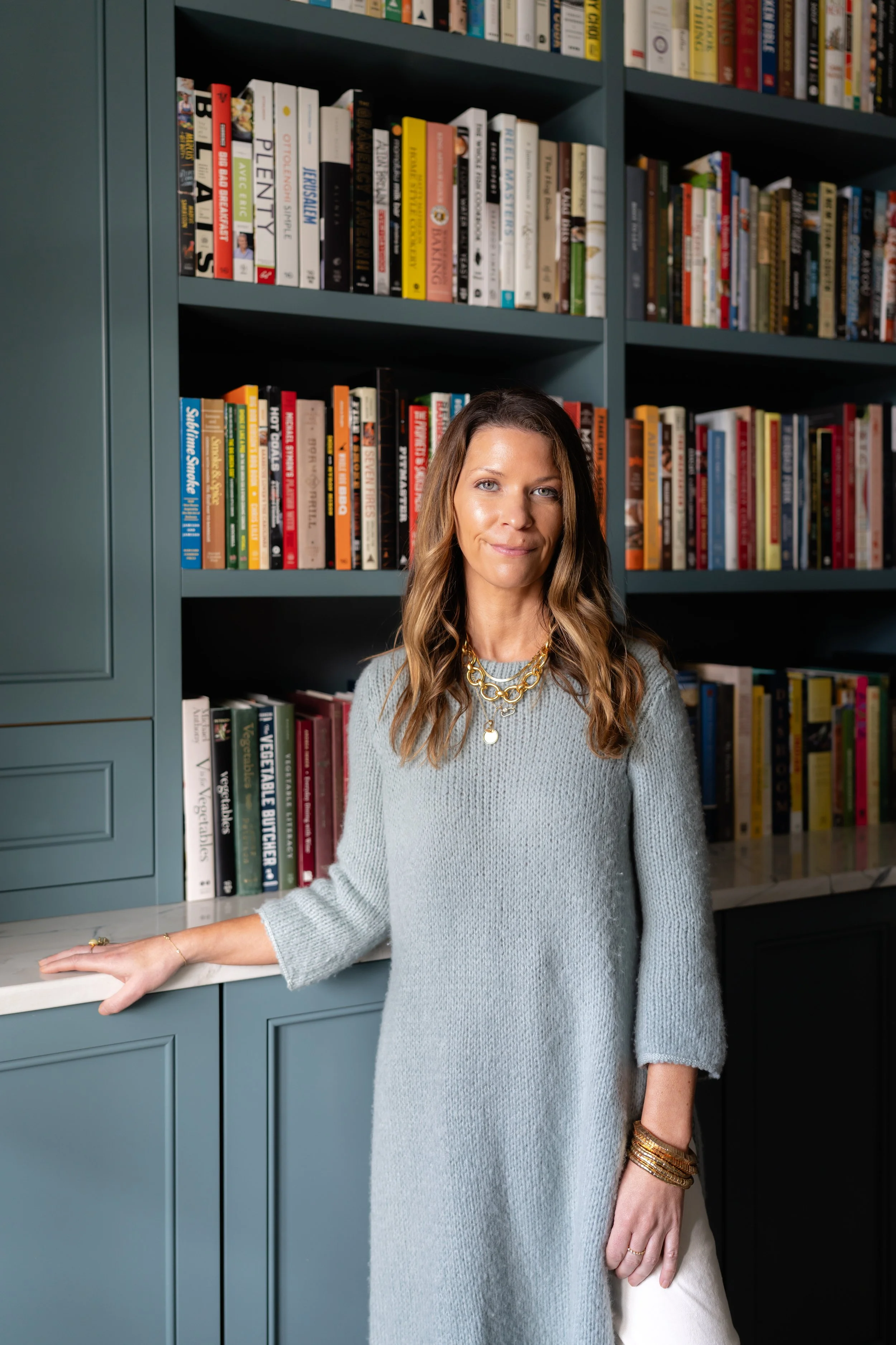 Personal branding headshot photography by Chandler Cox — woman posing in front of built-in bookshelf, Columbia SC personal branding and professional headshot photographer
