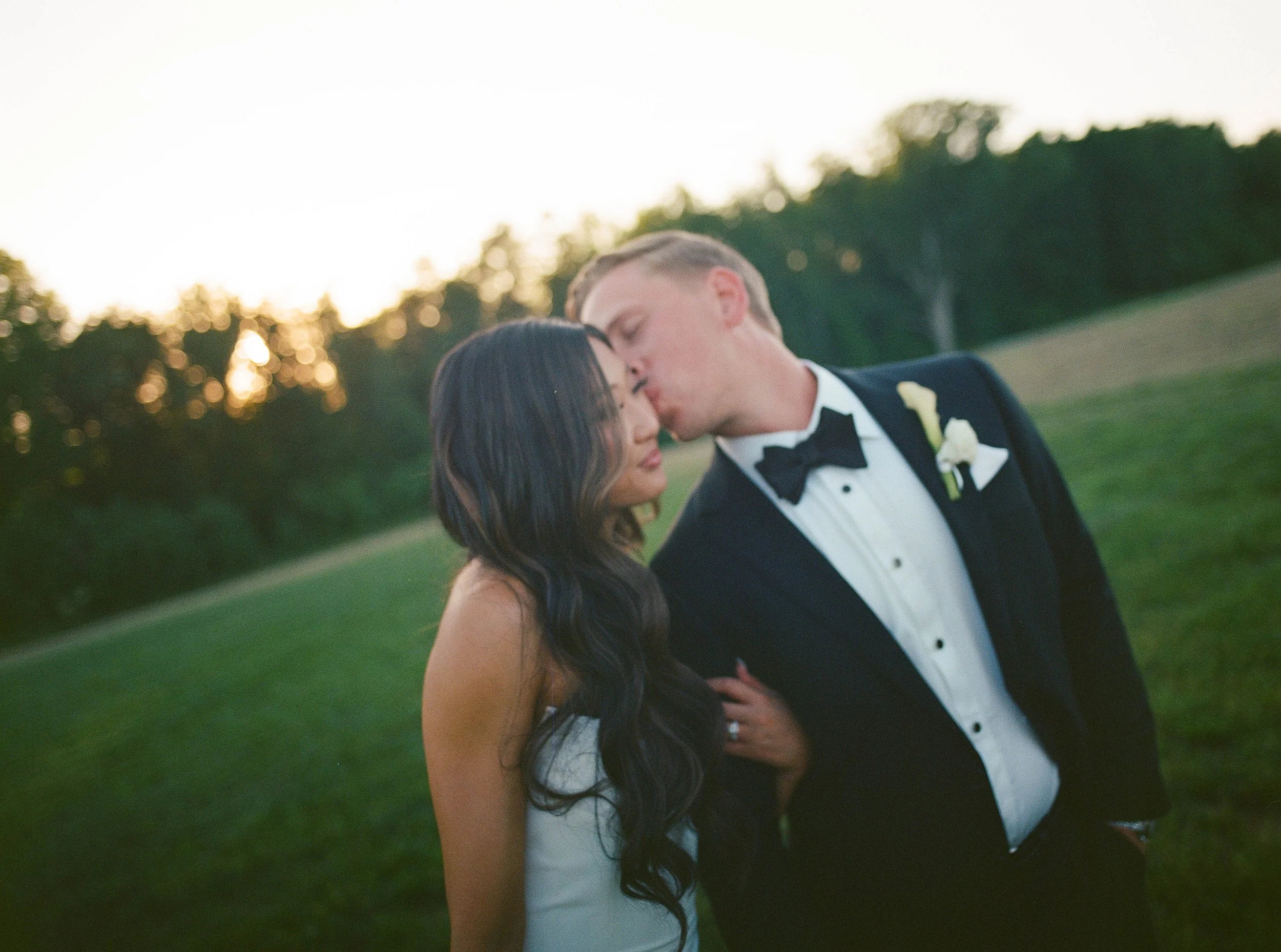 Bride and groom sharing an intimate kiss during golden hour outdoor wedding portraits shot on 120mm film by Columbia SC wedding photographer Chandler Cox