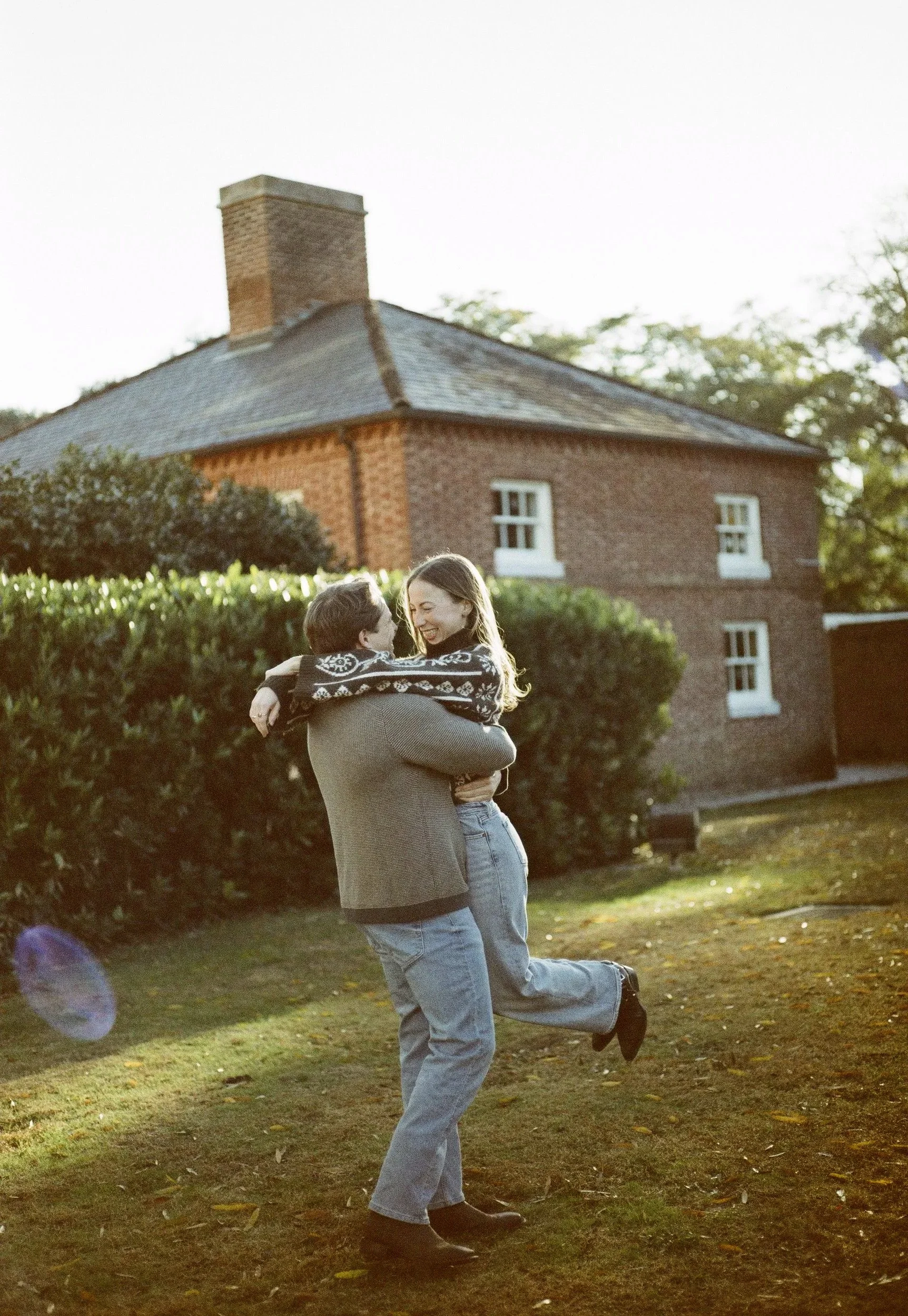 A bride and groom sharing a romantic embrace during golden hour at an outdoor engagement session in Columbia, SC