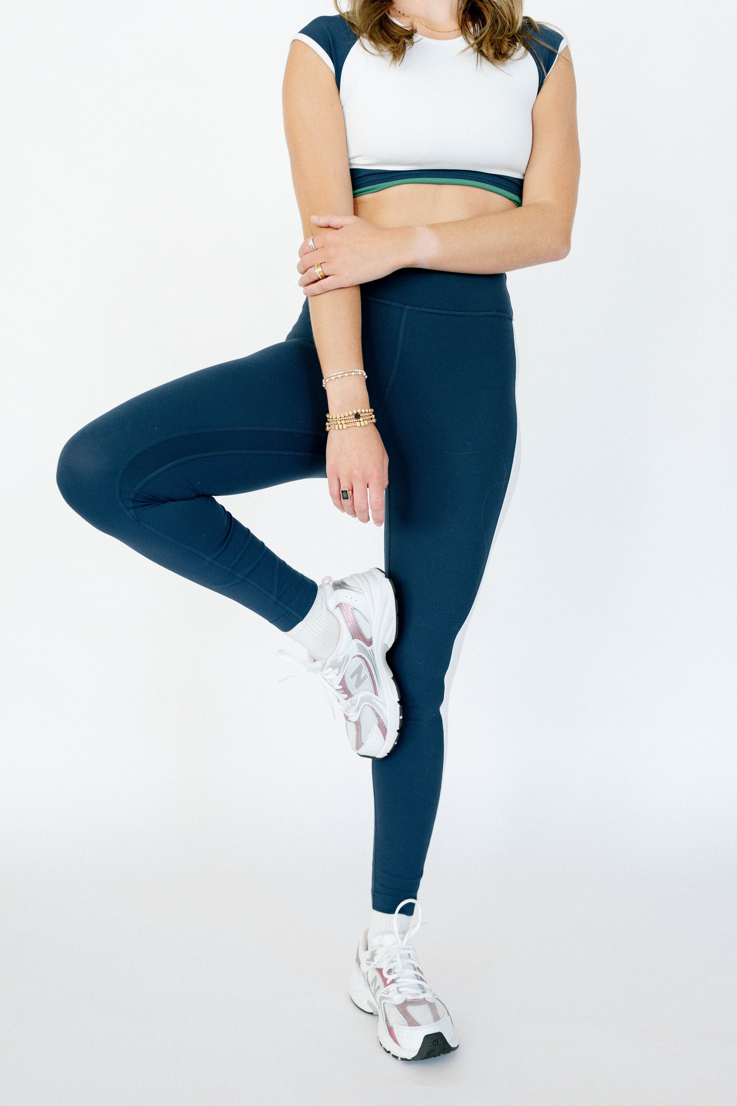 Activewear product photography by Chandler Cox — woman in navy high-waist leggings and white sports bra on white background, Columbia SC fitness apparel brand photographer