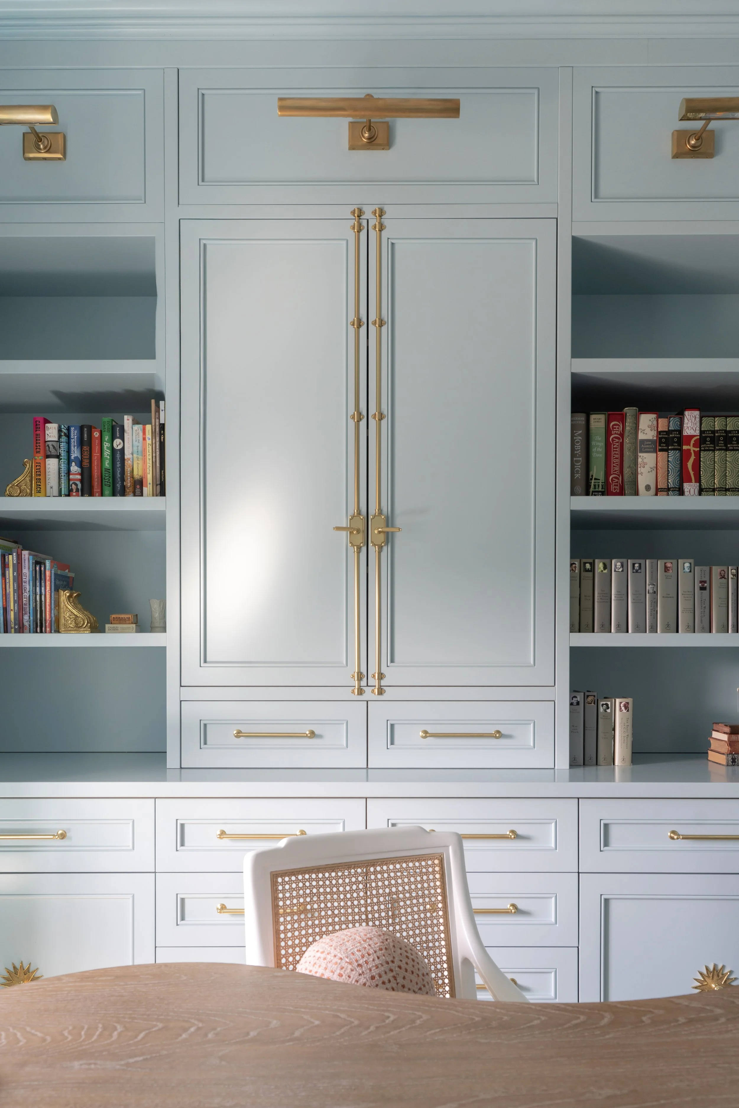 Interior and architectural photography by Chandler Cox — custom built-in cabinetry with brass hardware and styled bookshelves in home office, Columbia SC interior and real estate photographer