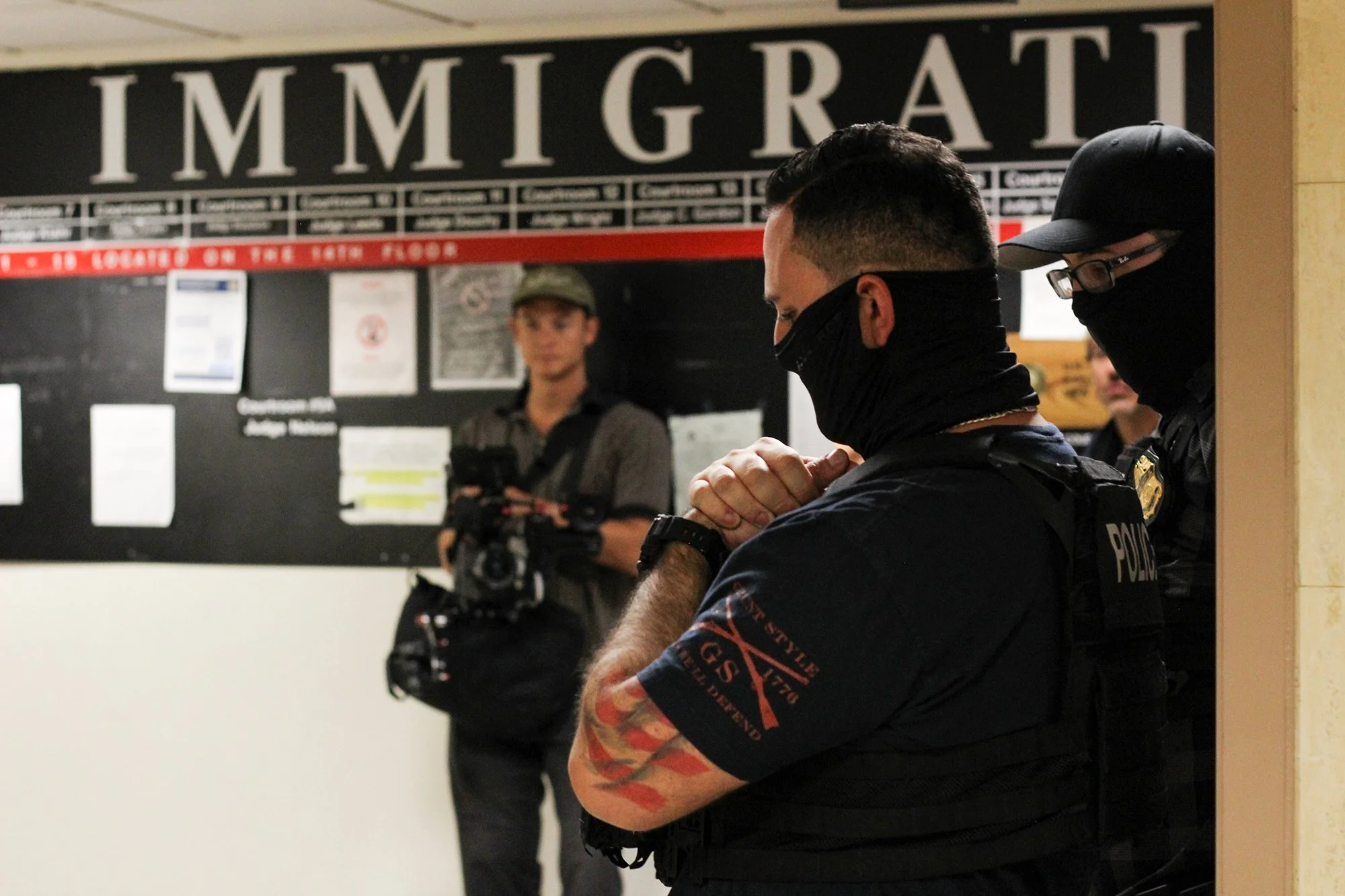 Federal Immigration and Customs Enforcement officers wait outside an immigration courtroom at 26 Federal Plaza, Aug. 27, 2025 (Photo by Sandra Sadek)