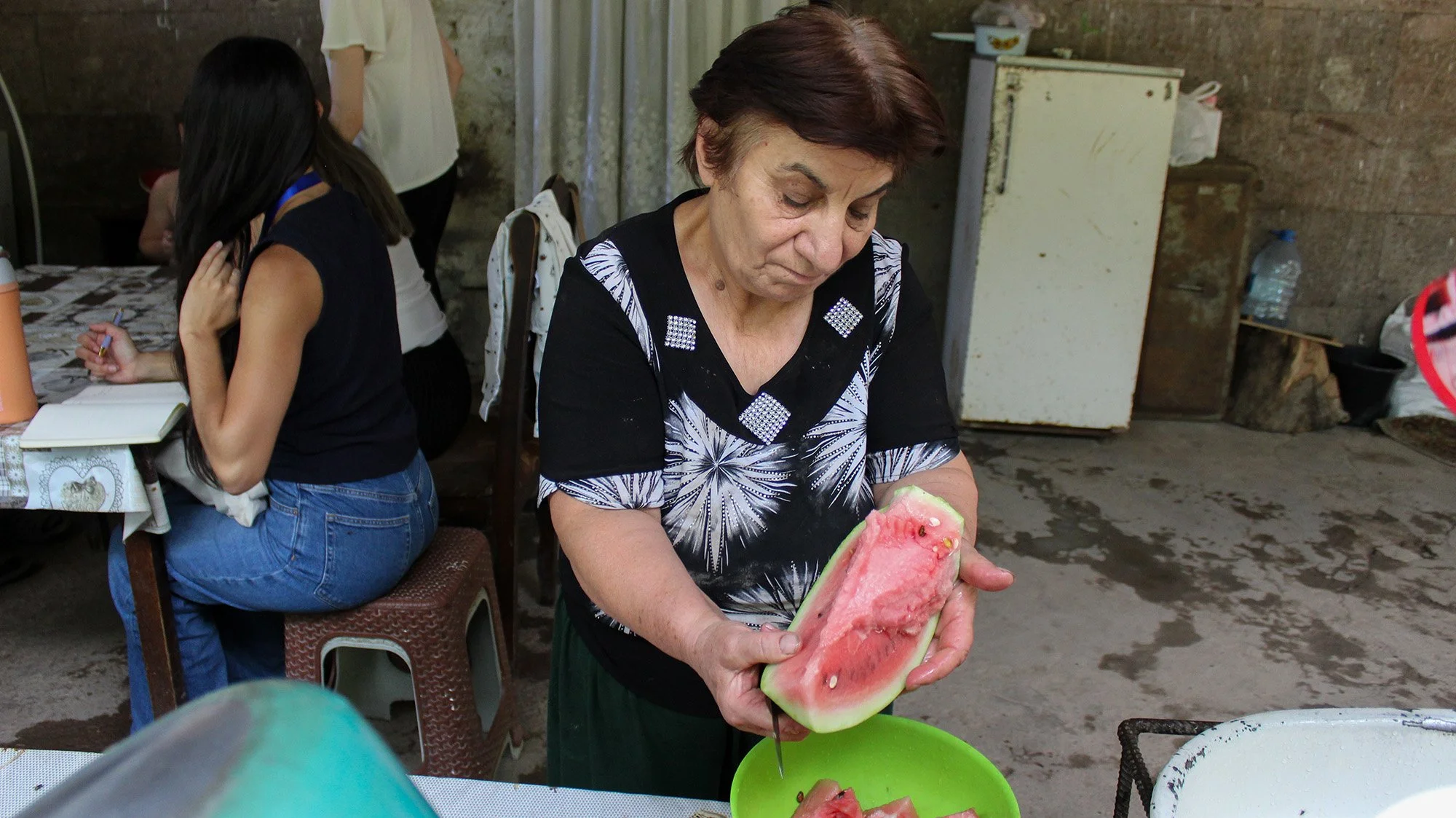 Hasmik, 67, cuts up watermelon in her home in the village of Nerkin Hand, on the border with Azerbaijan.