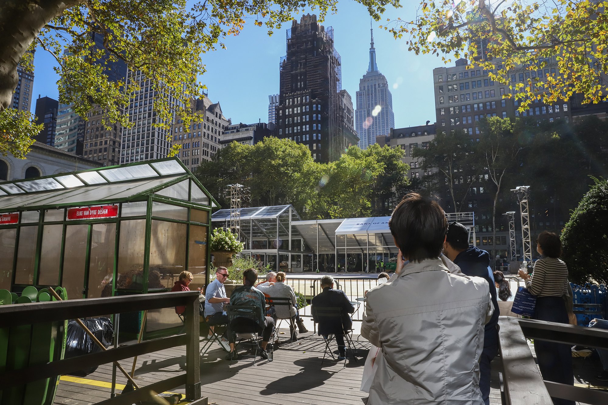 A visitor takes a photo of Bryant Park as the Winter Village is being set up, November 2025 (Photo by Sandra Sadek)