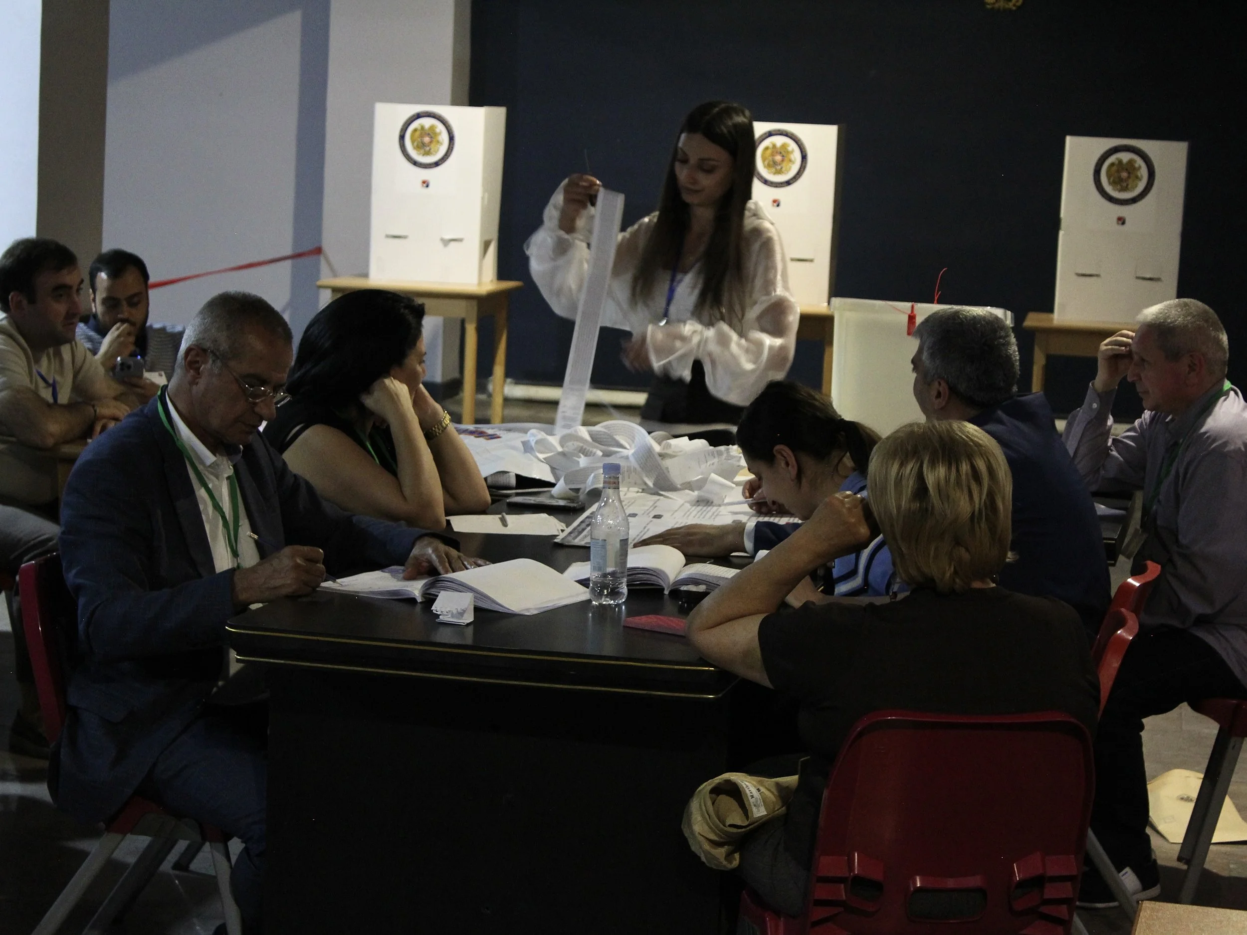 Election officials begin the process of counting ballots after polls closed at 8 p.m. on June 7. 