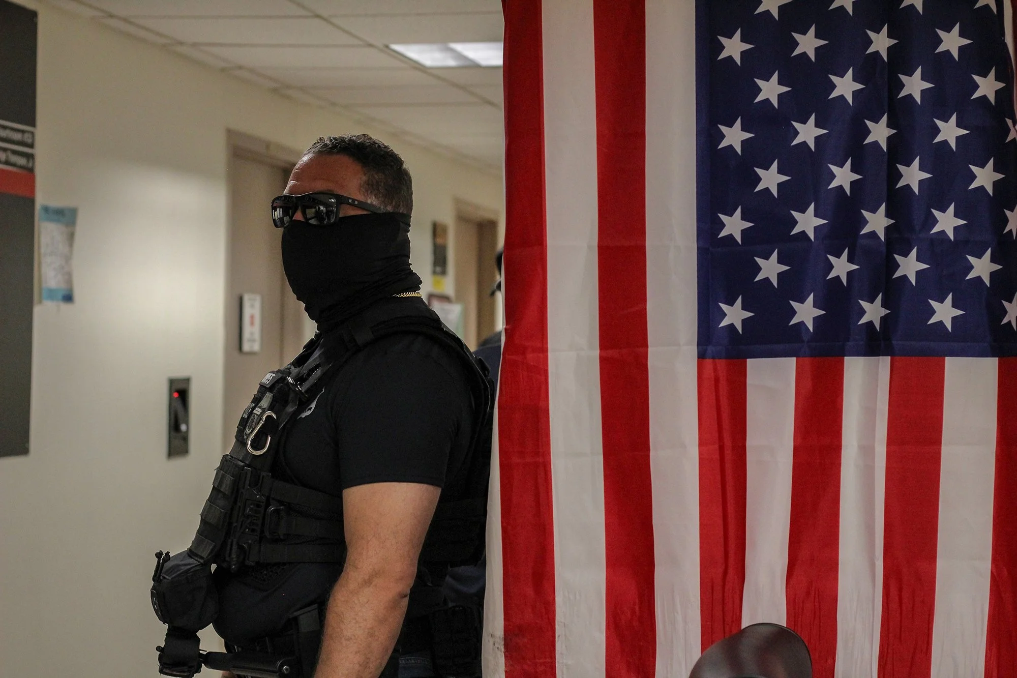 Federal Immigration and Customs Enforcement officers wait outside an immigration courtroom at 26 Federal Plaza, Aug. 27, 2025 (Photo by Sandra Sadek)